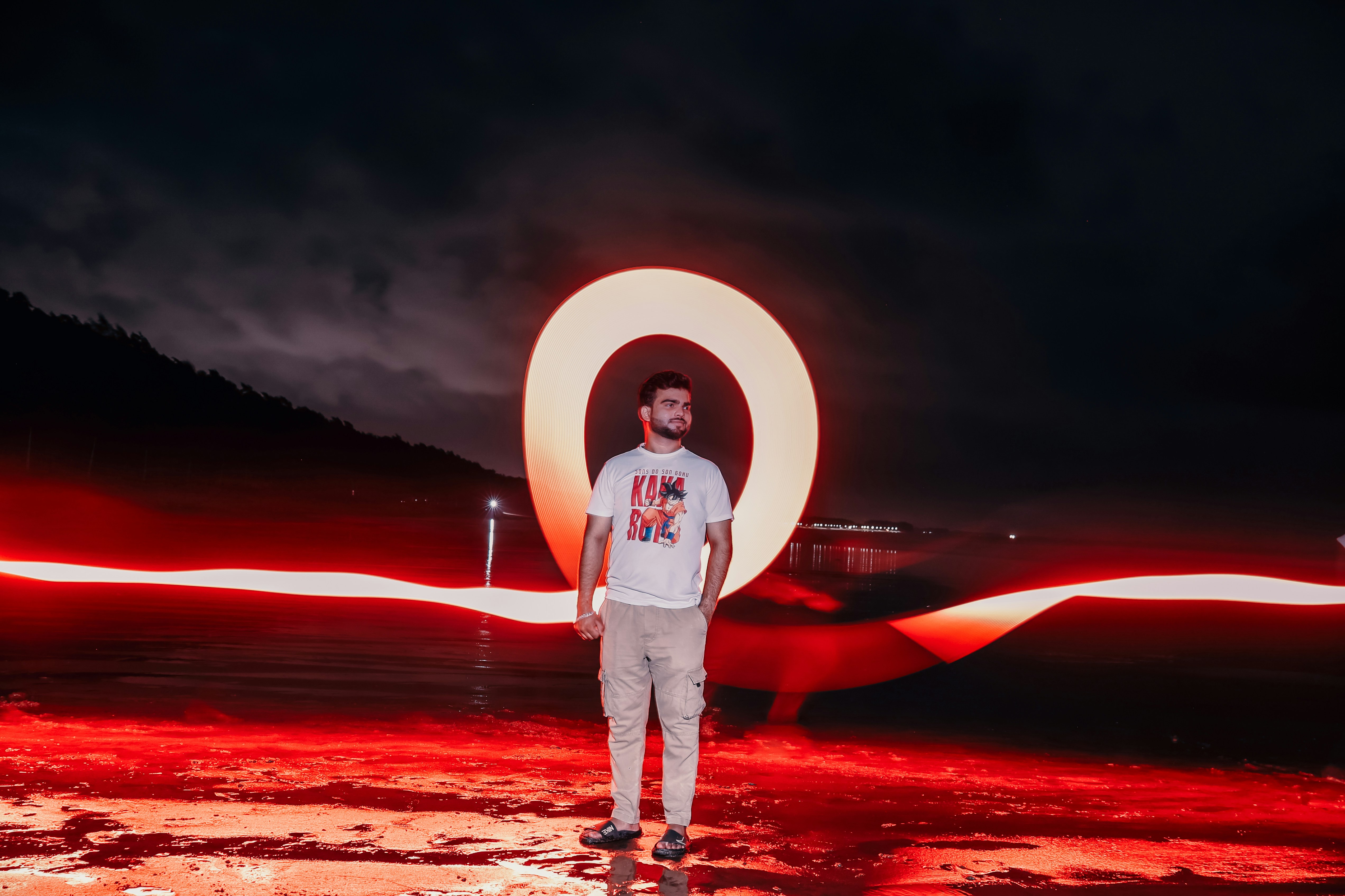 A man standing in front of a red light