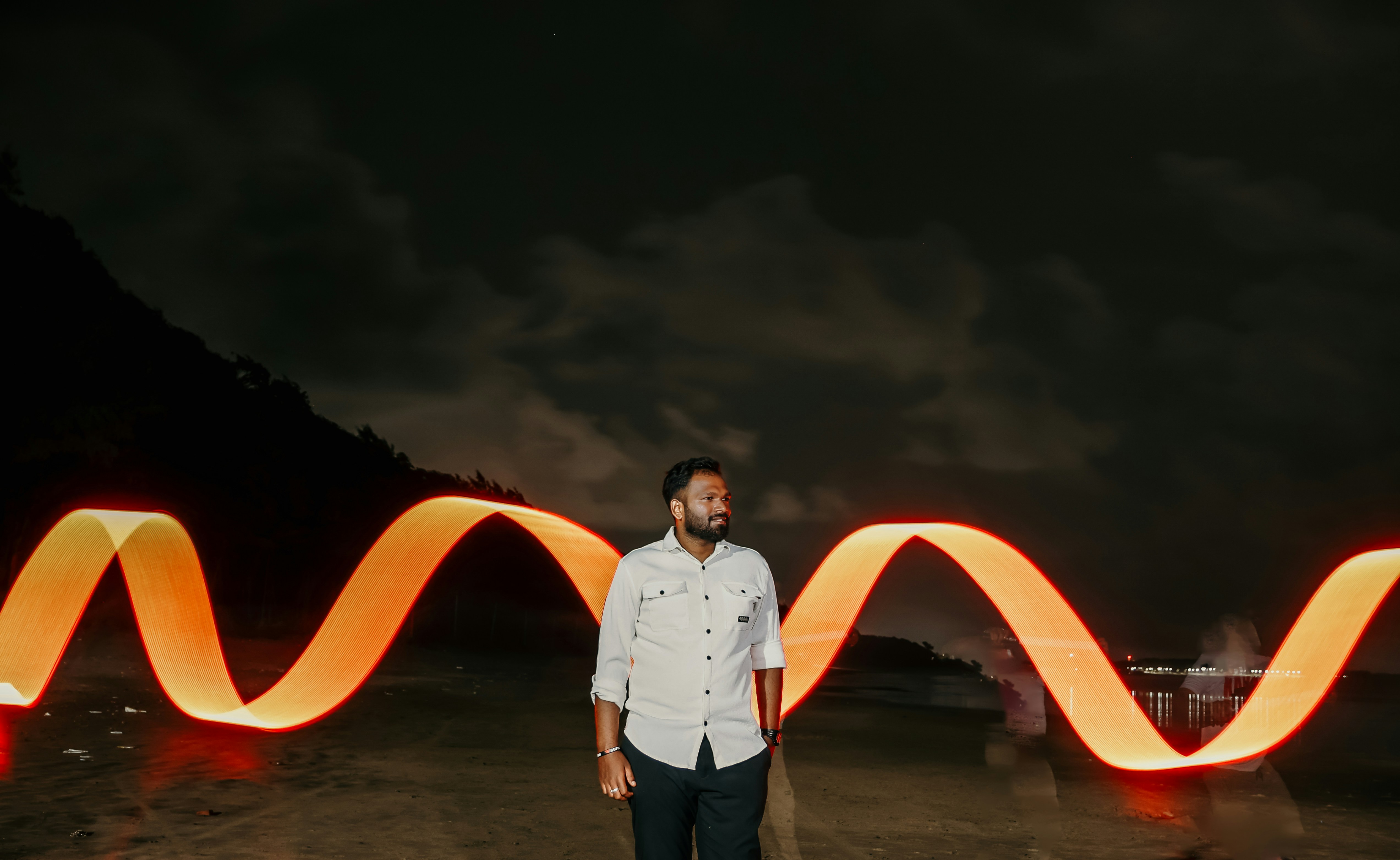 A man standing in front of a wave of light