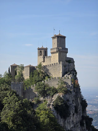 A castle perched on top of a cliff San Marino
