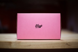 A pink box sitting on top of a wooden table