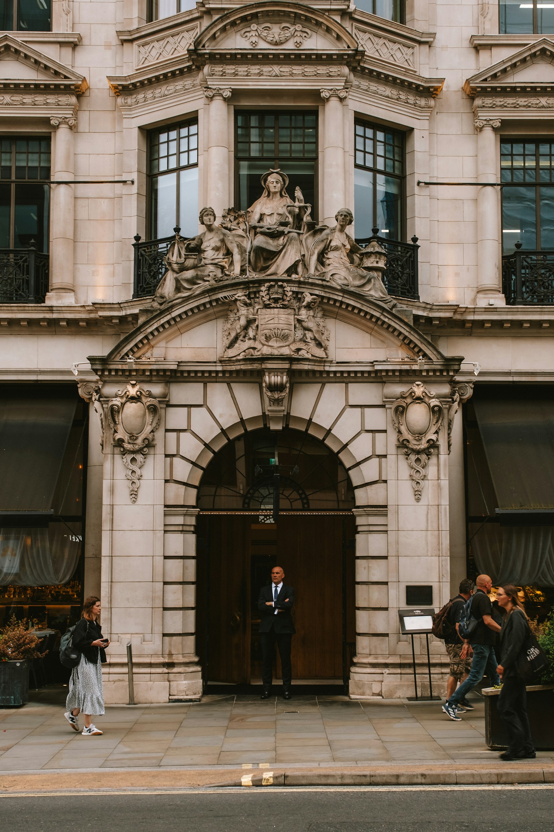 A couple of people that are standing in front of a building