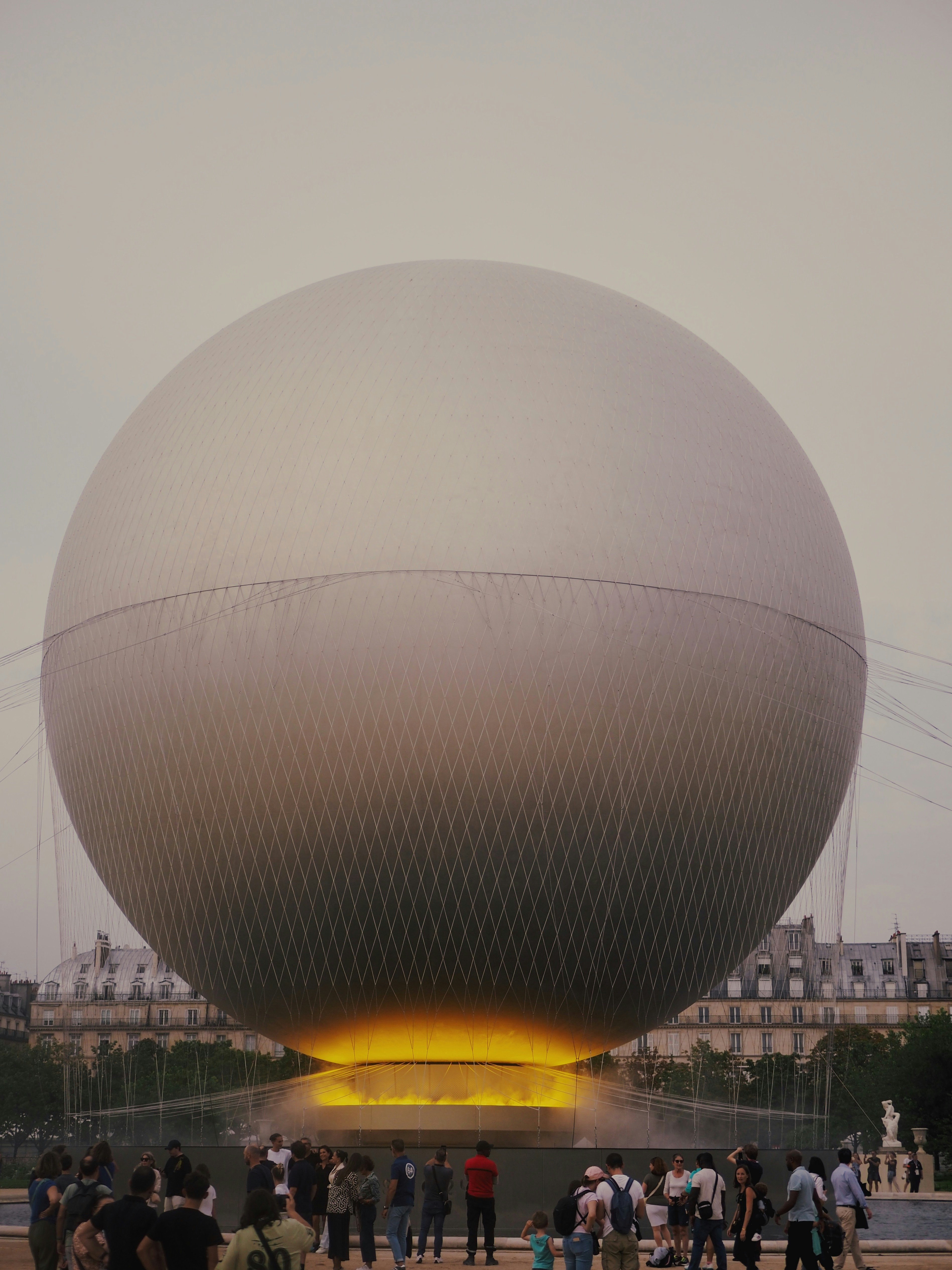 A group of people standing in front of a large ball