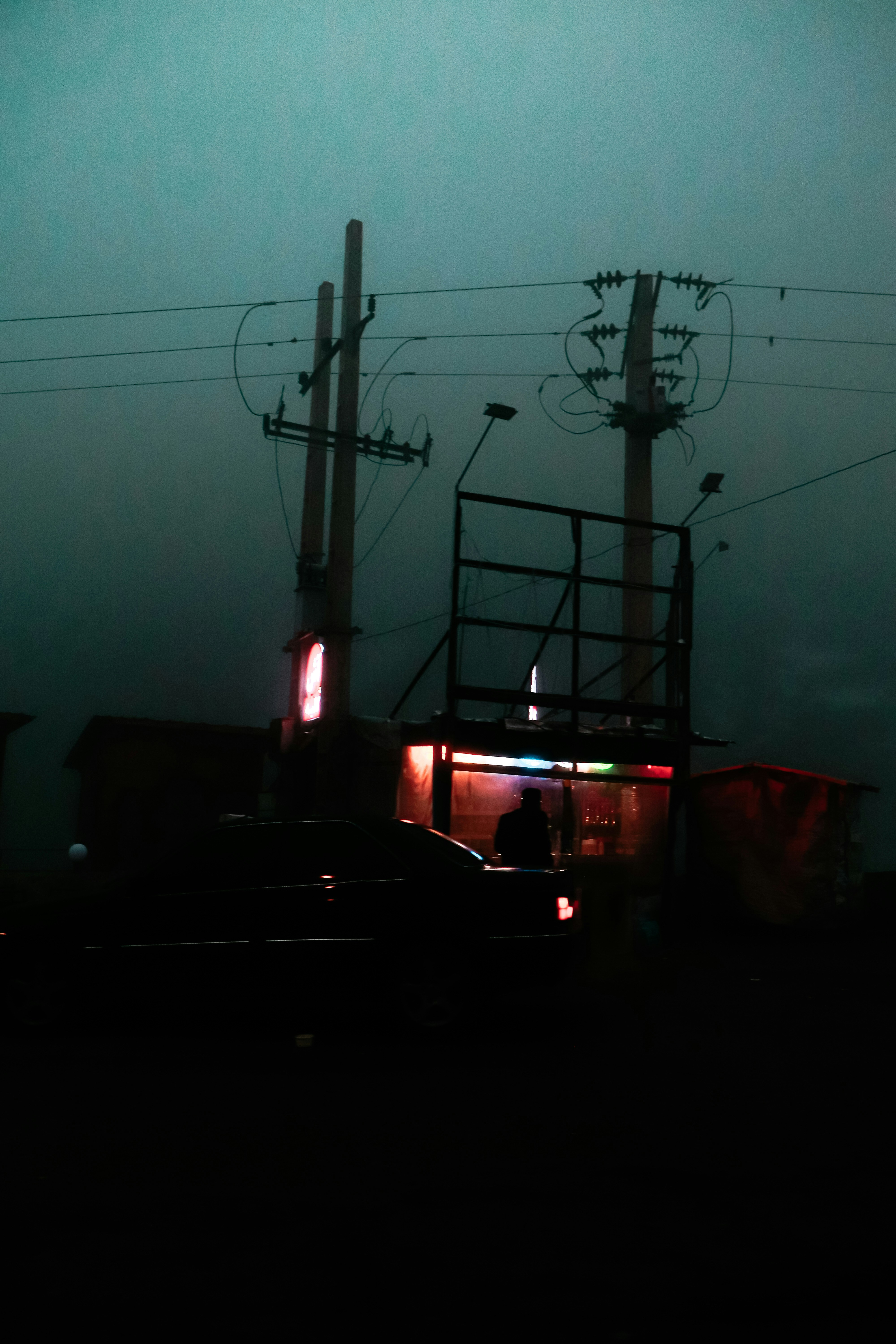 A truck driving down a street next to power lines