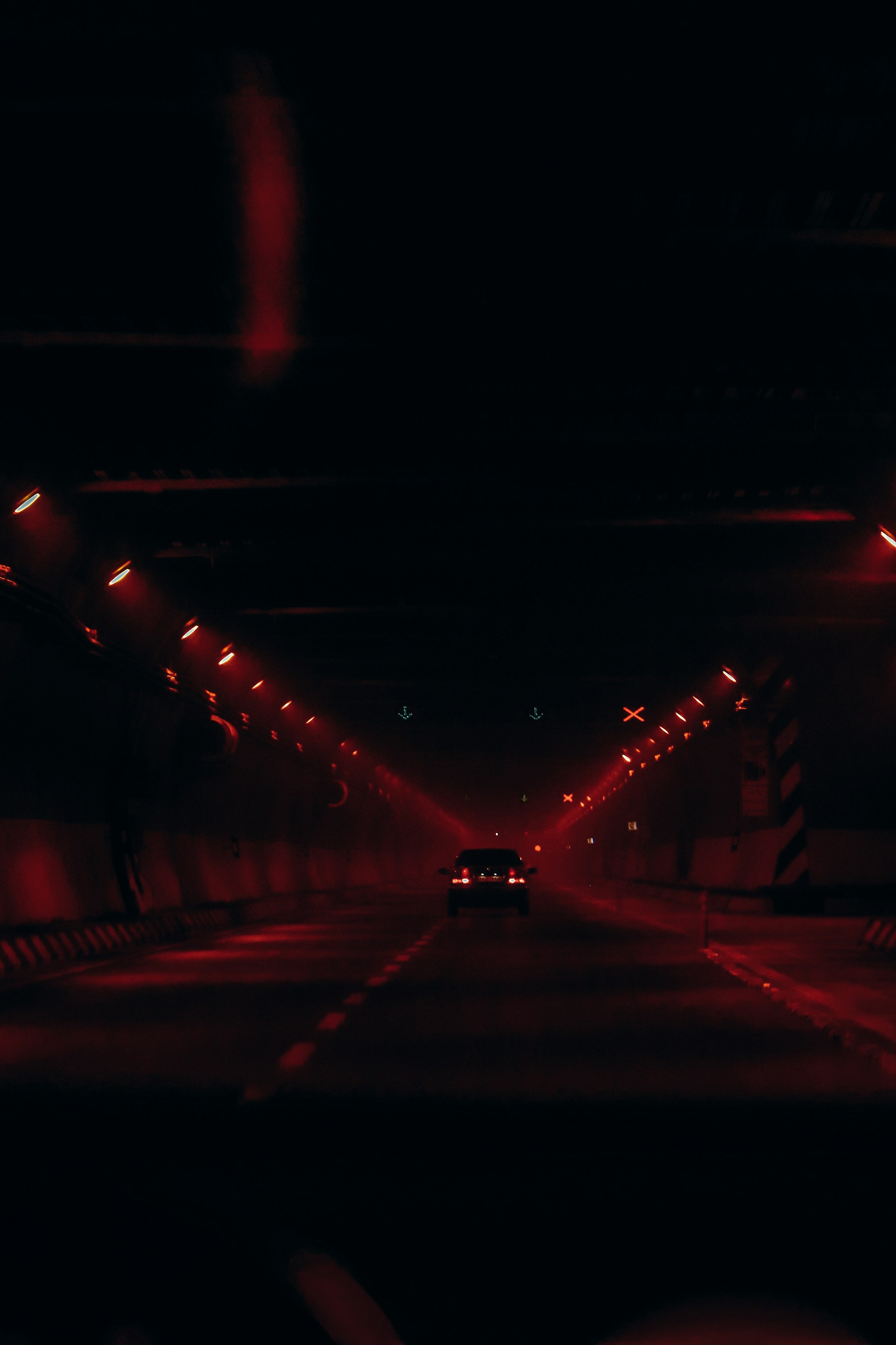 A car driving down a dark street at night