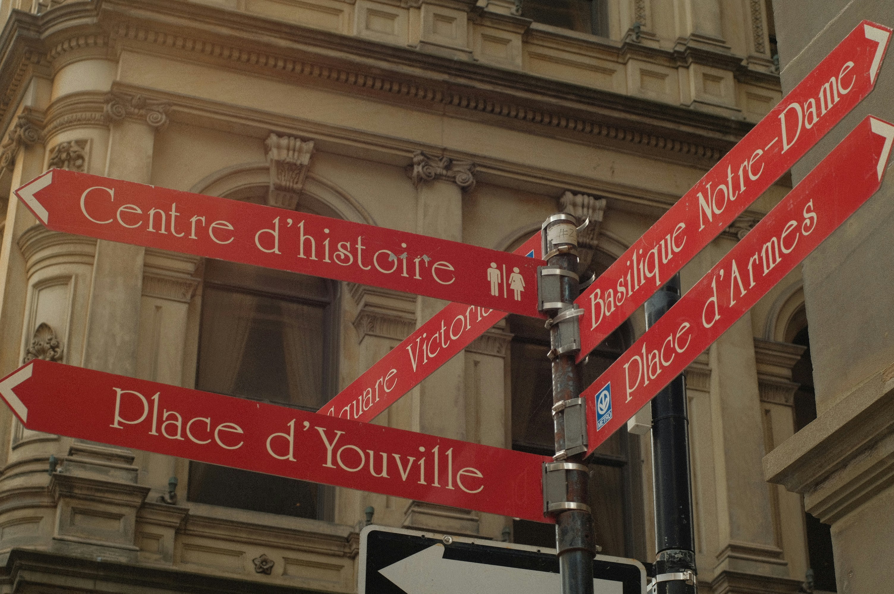 A street sign in front of a tall building