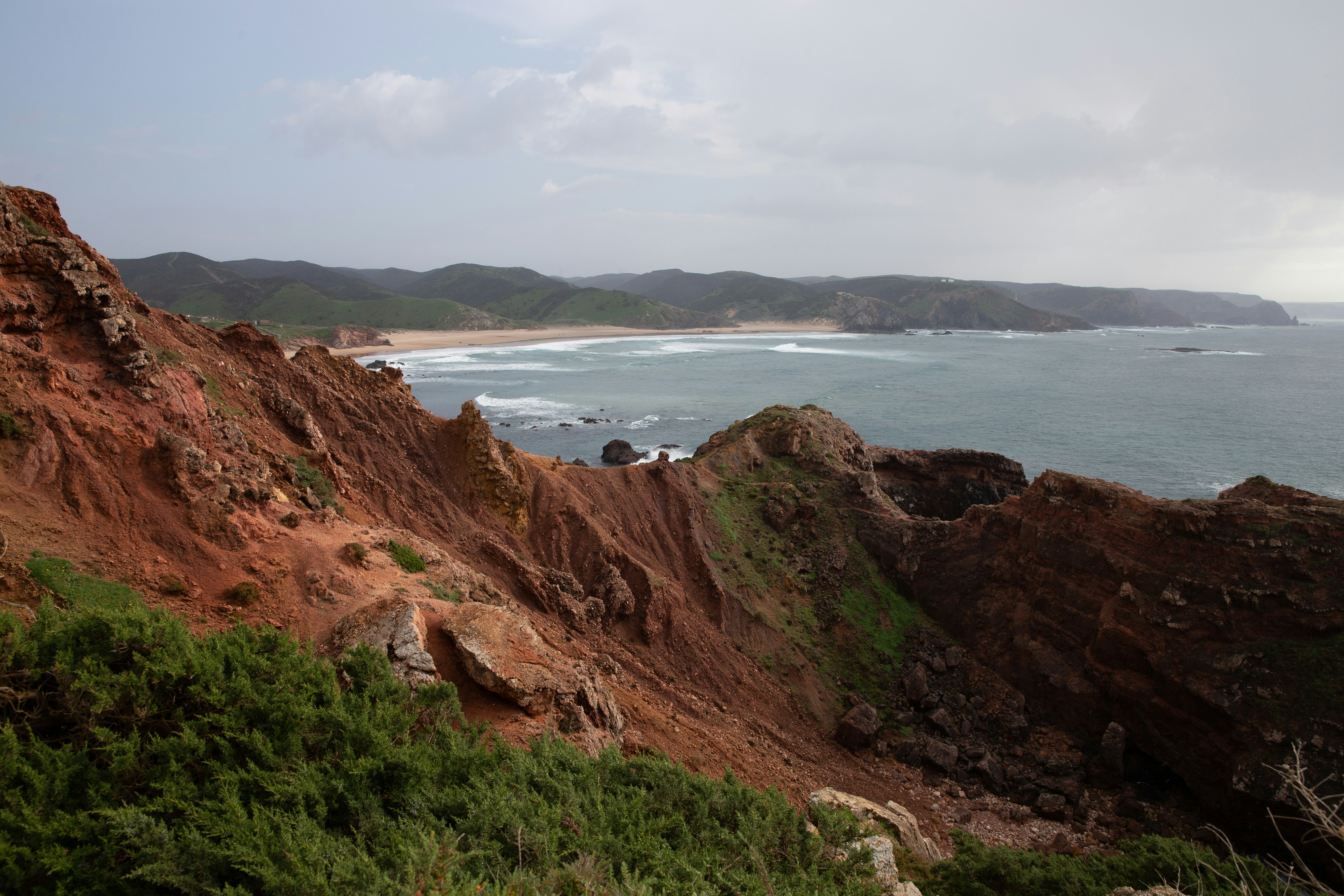 A view of the ocean from the top of a hill