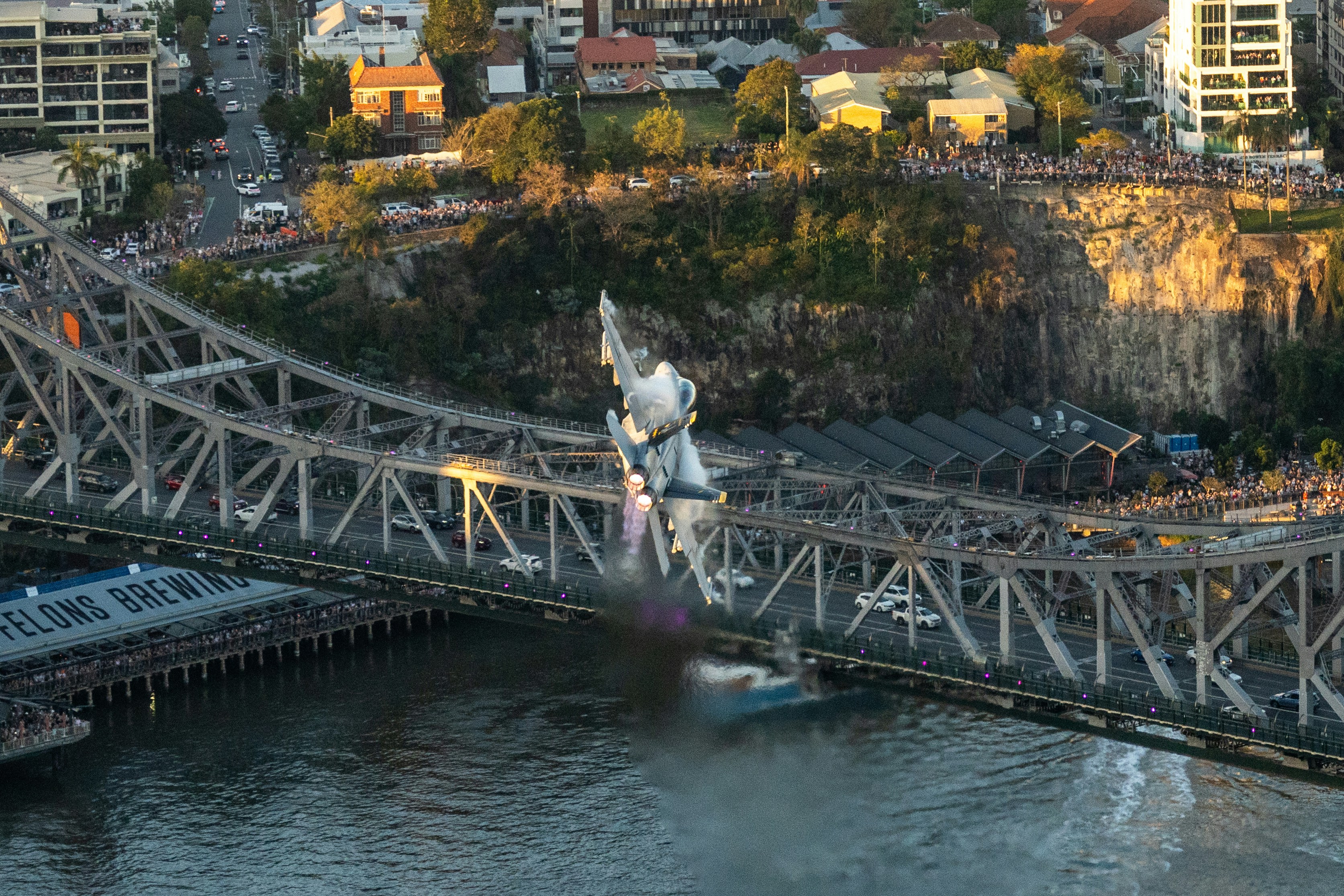 A bridge over a body of water with a city in the background