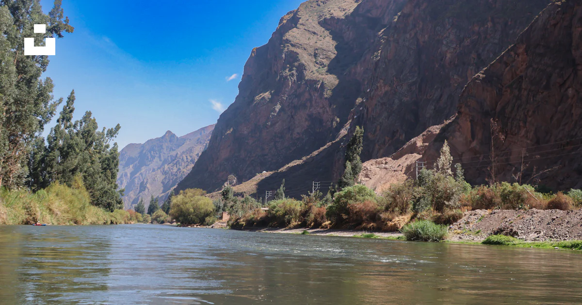 Navigable Rivers Peru A view of a river with mountains in the background photo – Free Peru ...