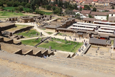 An aerial view of a village with a green field