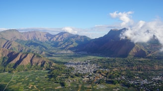An aerial view of a city and mountains