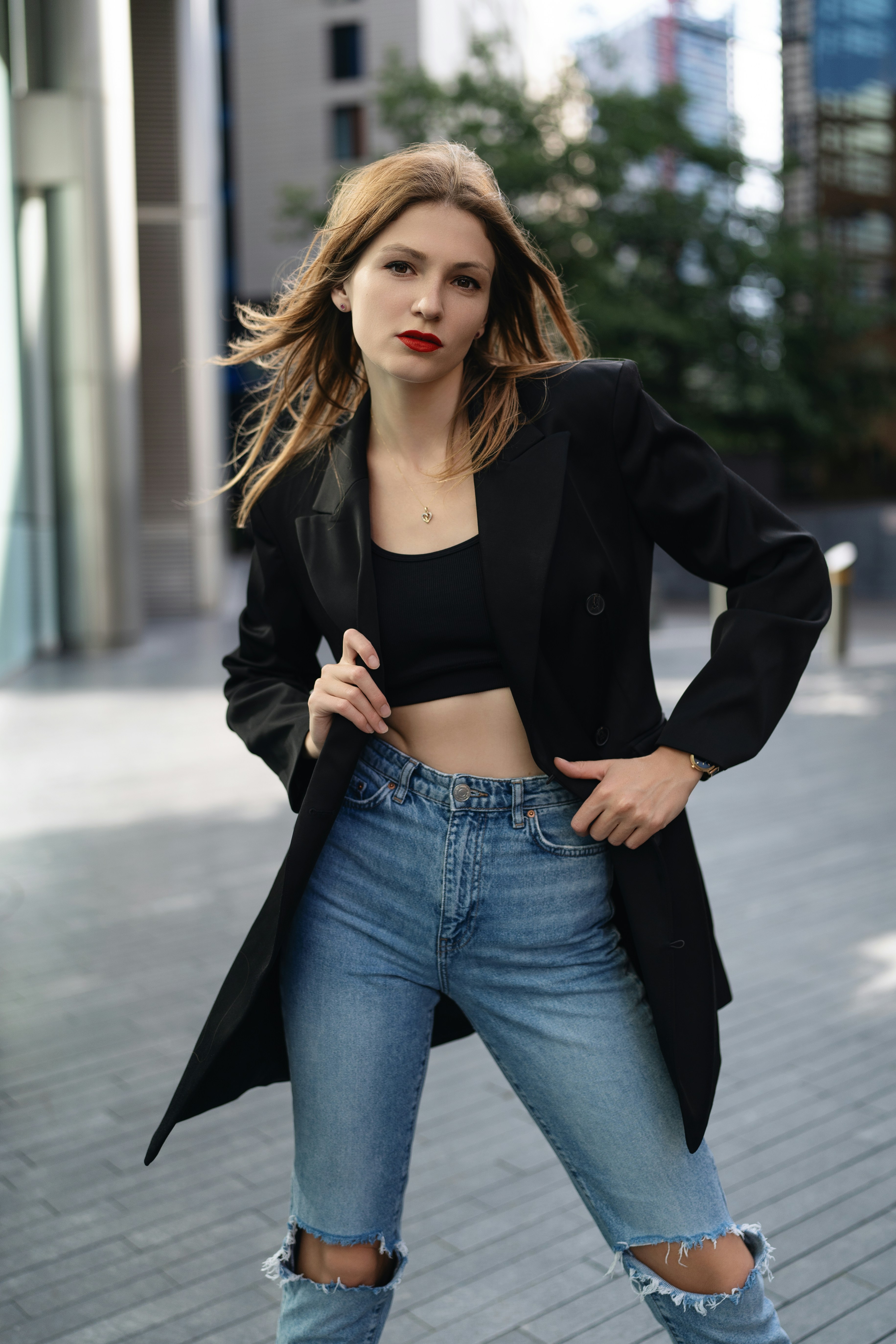 A woman in ripped jeans and a black jacket