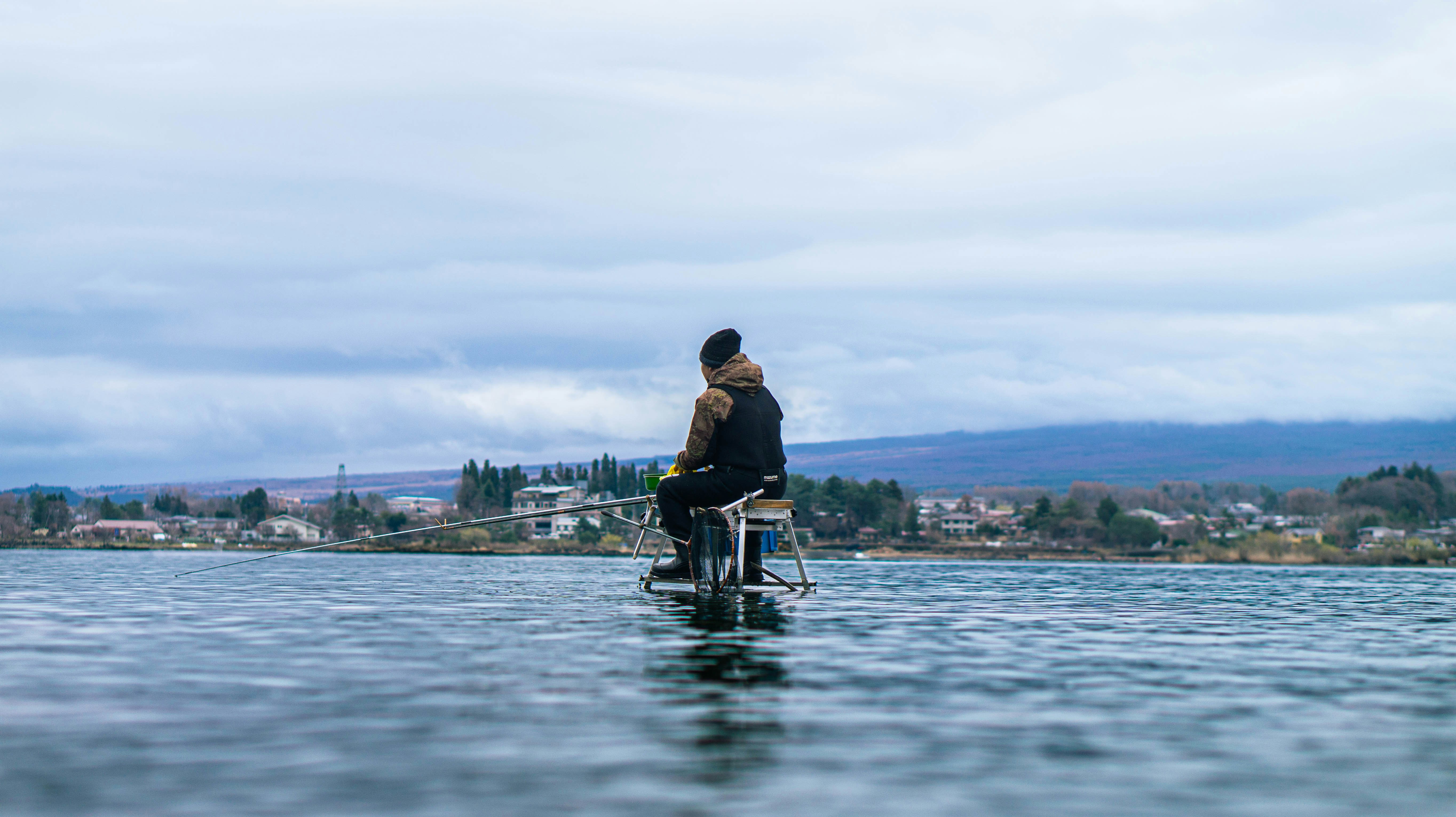 A person sitting on a boat in the water