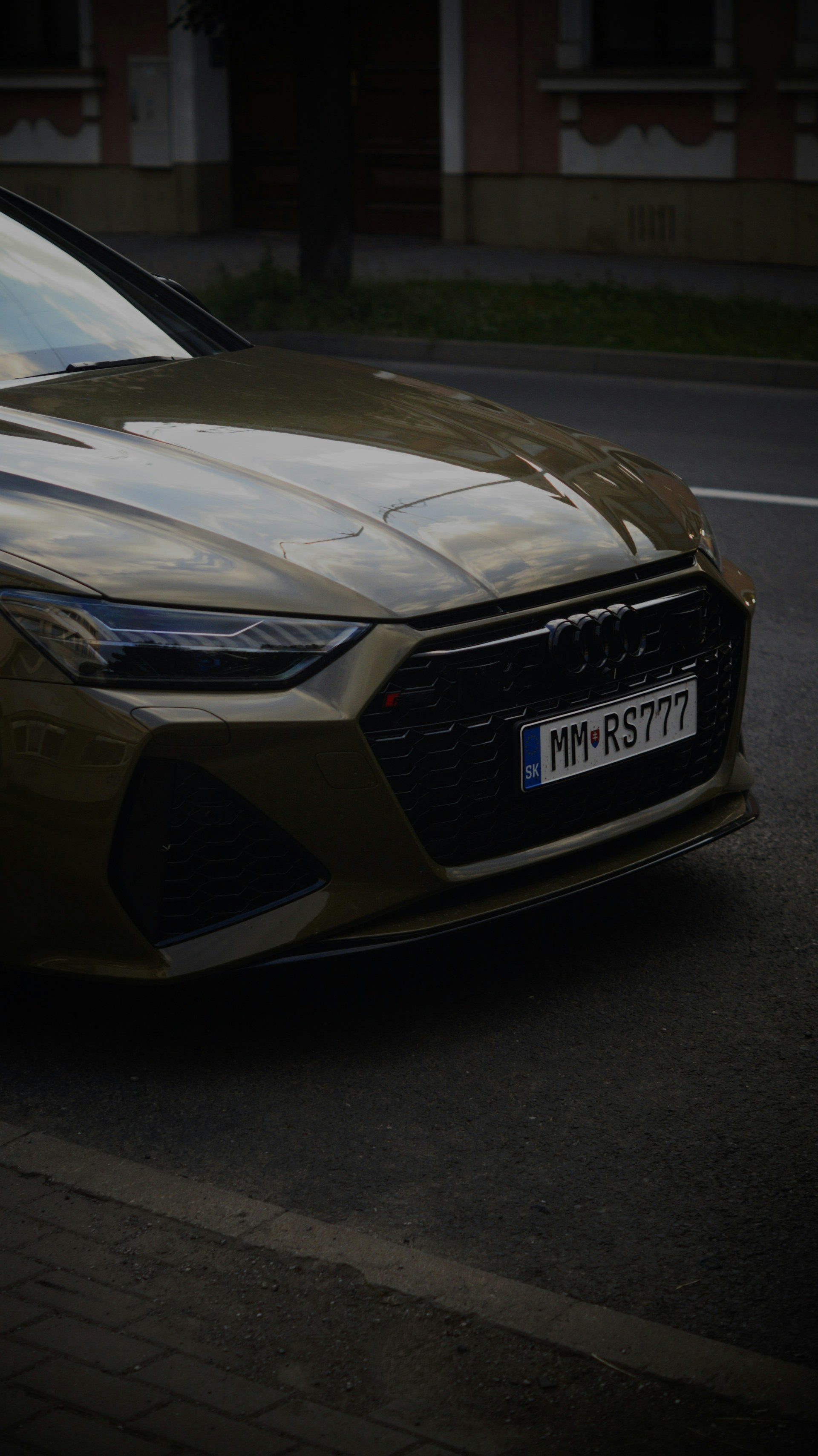 A brown car parked on the side of the road