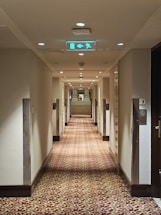 A long hallway with a sign on the wall