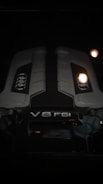 A close up of a car engine in the dark