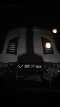 A close up of a car engine in the dark