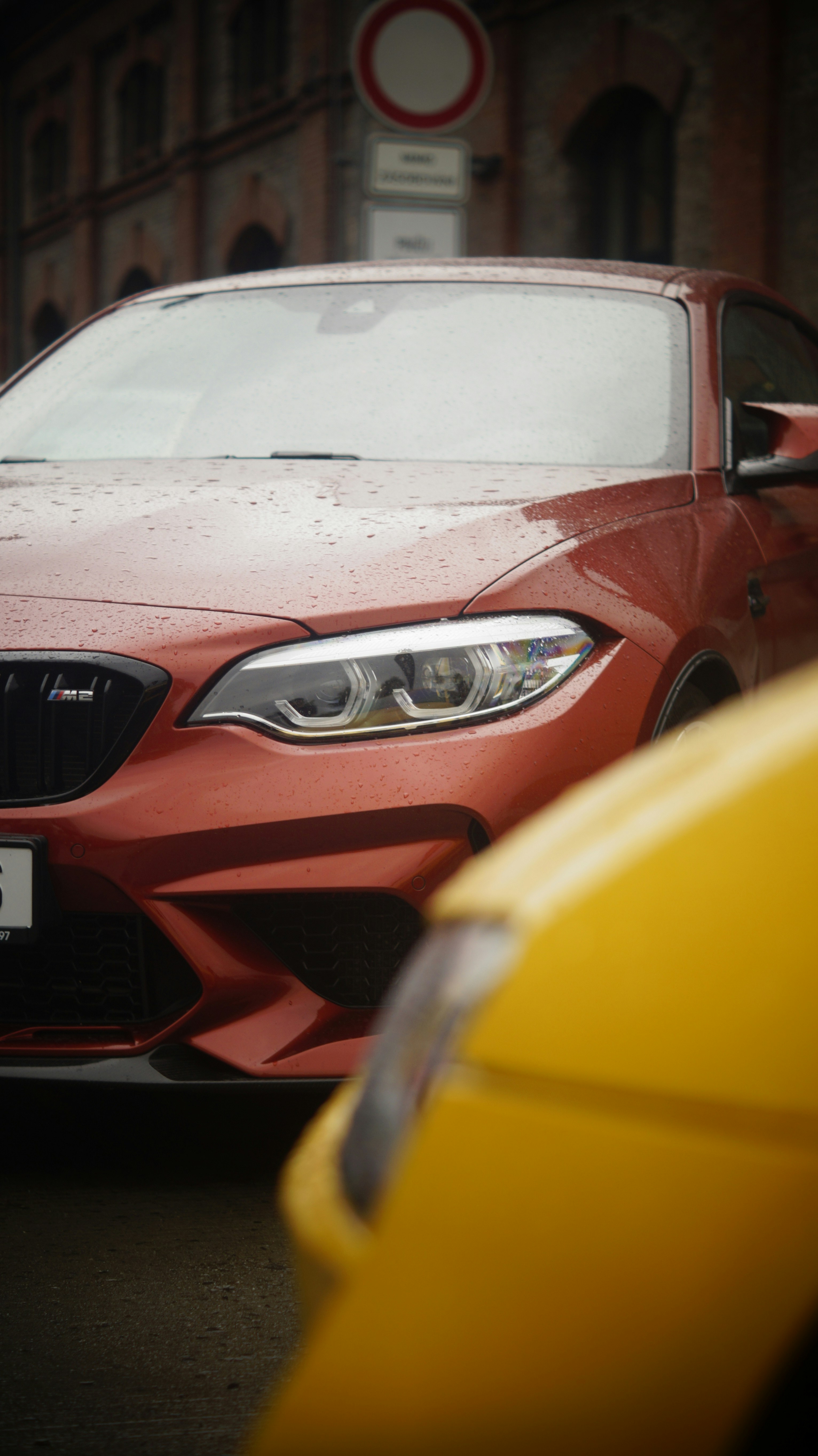 A red car parked next to a yellow car