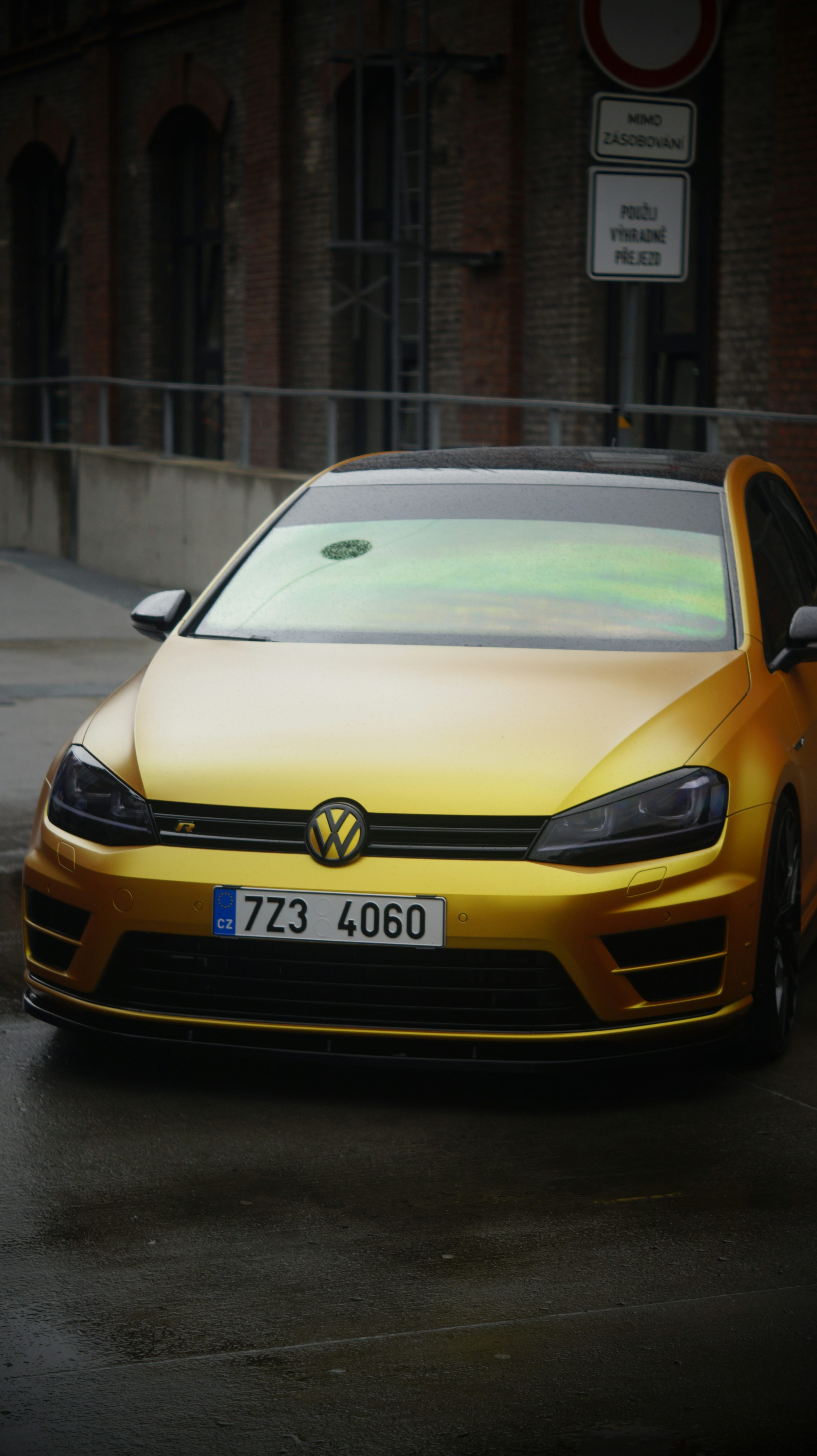 A yellow car parked on the side of the road