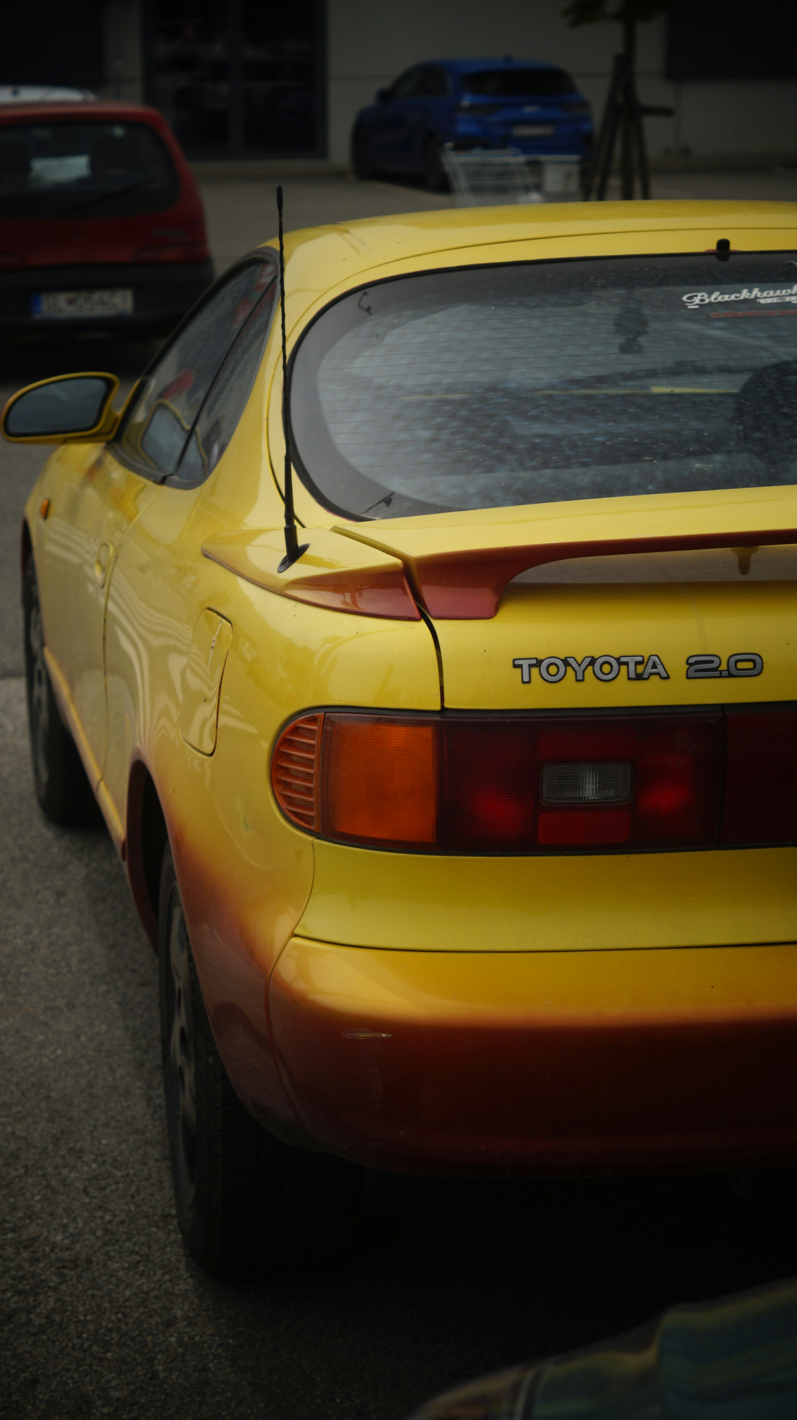 A yellow sports car parked in a parking lot