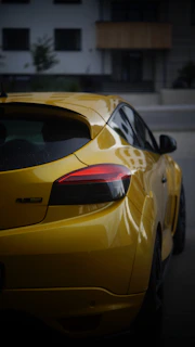 A yellow sports car parked in a parking lot