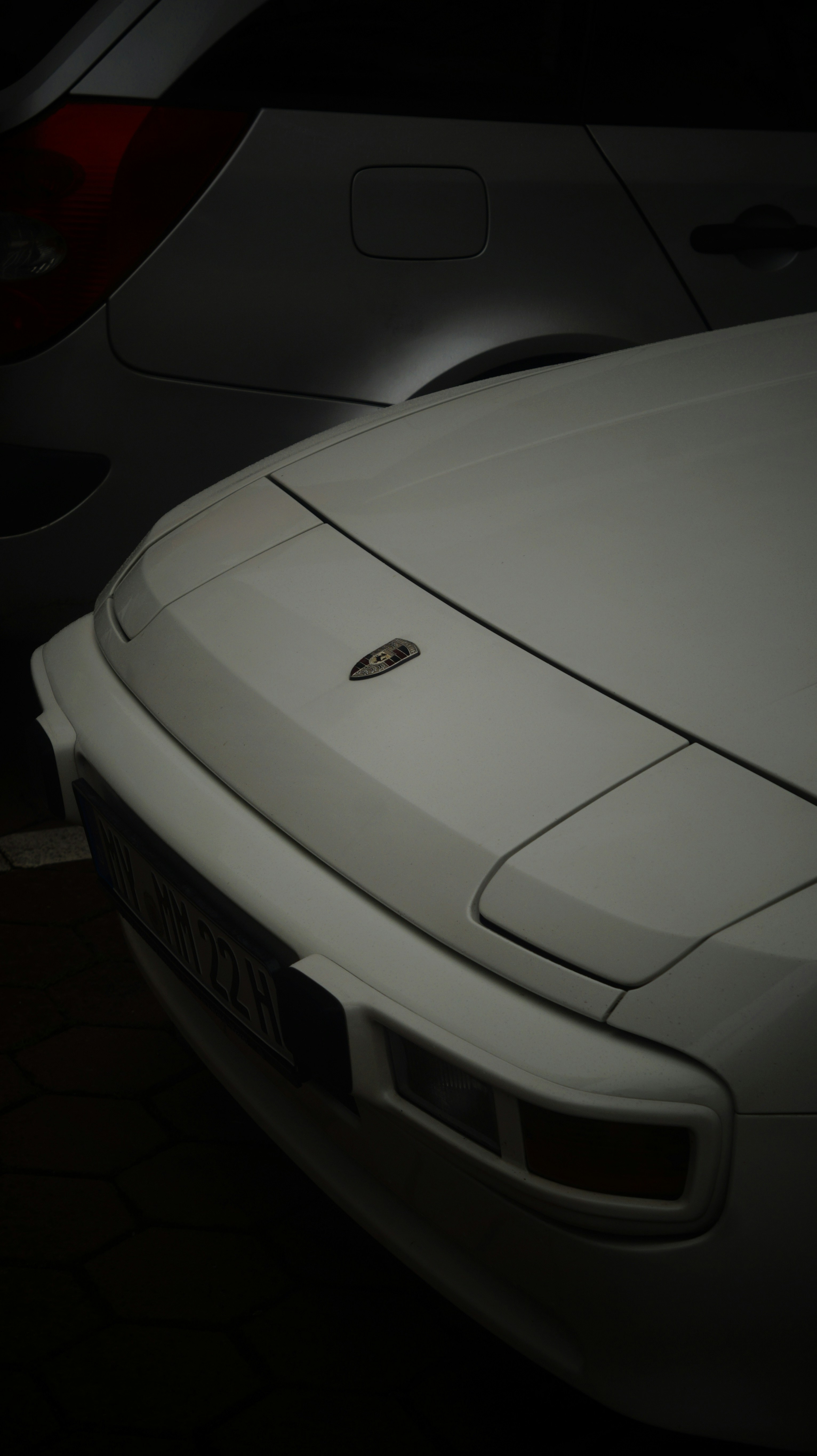 A white sports car parked in a parking lot
