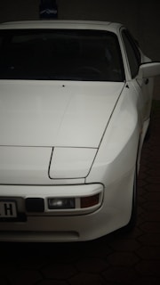 A white car parked in a driveway at night