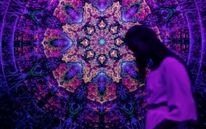 A person standing in front of a colorful wall