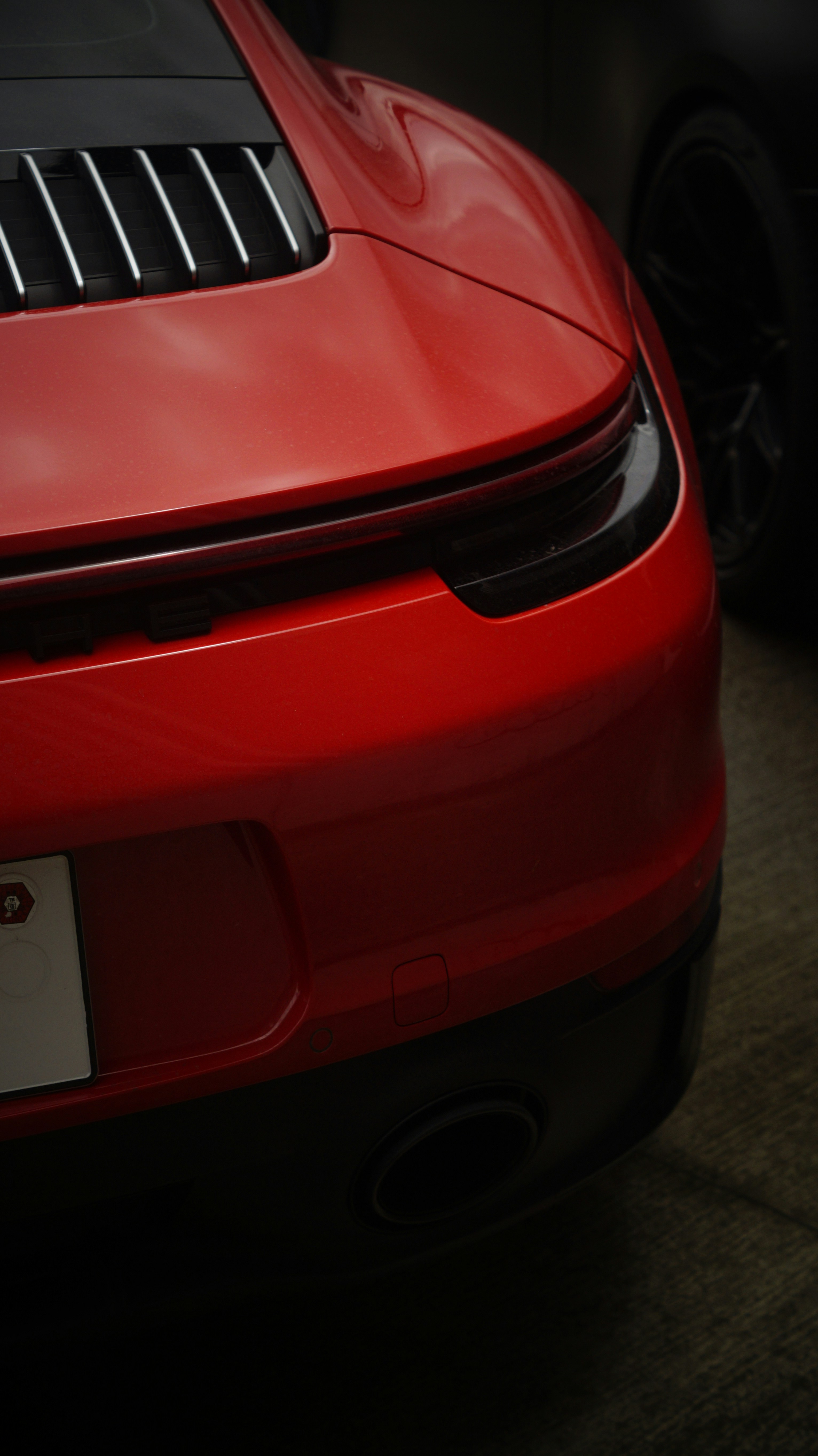 A red sports car parked in a parking lot
