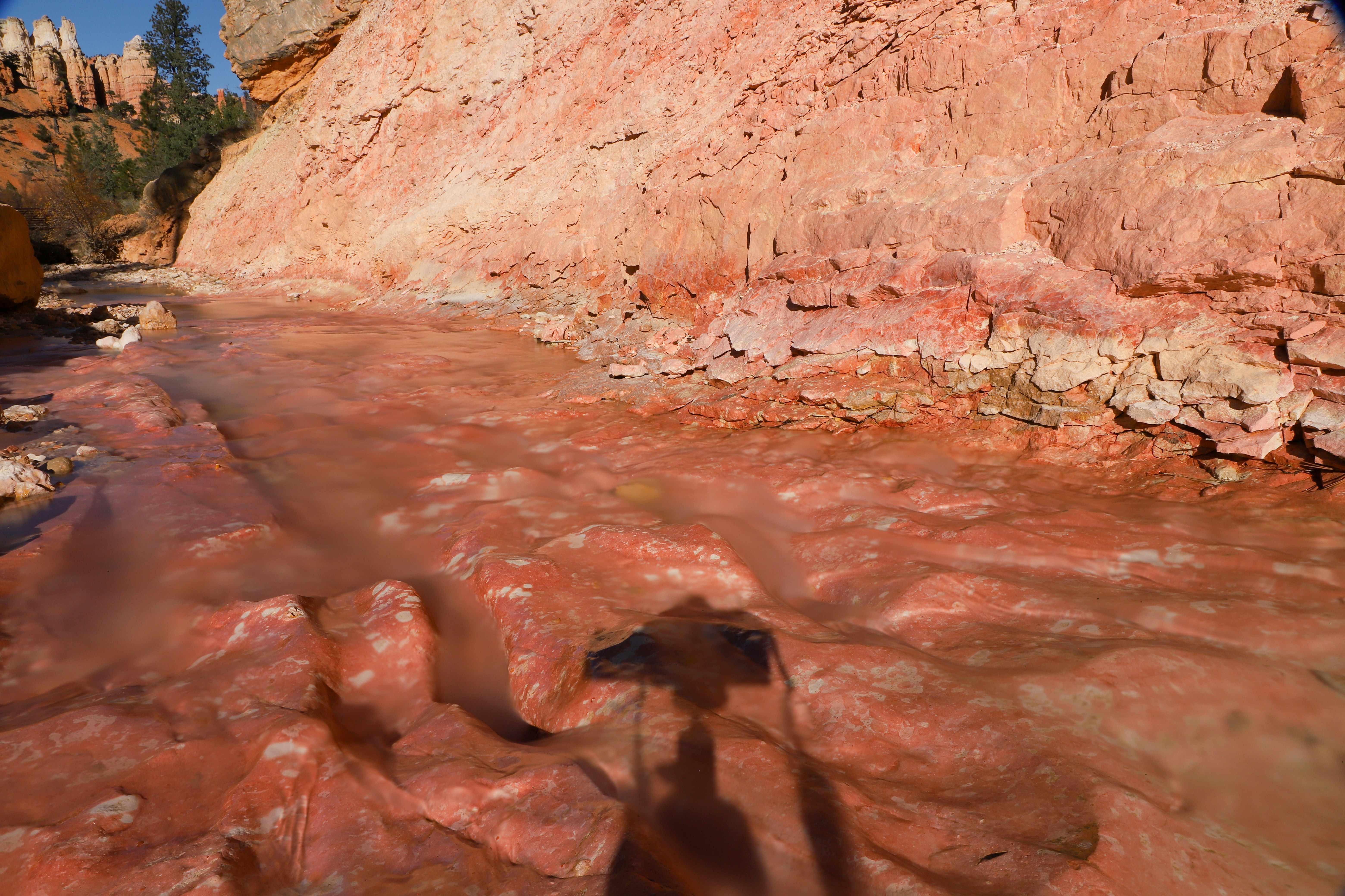 There is a rock formation in the middle of a river