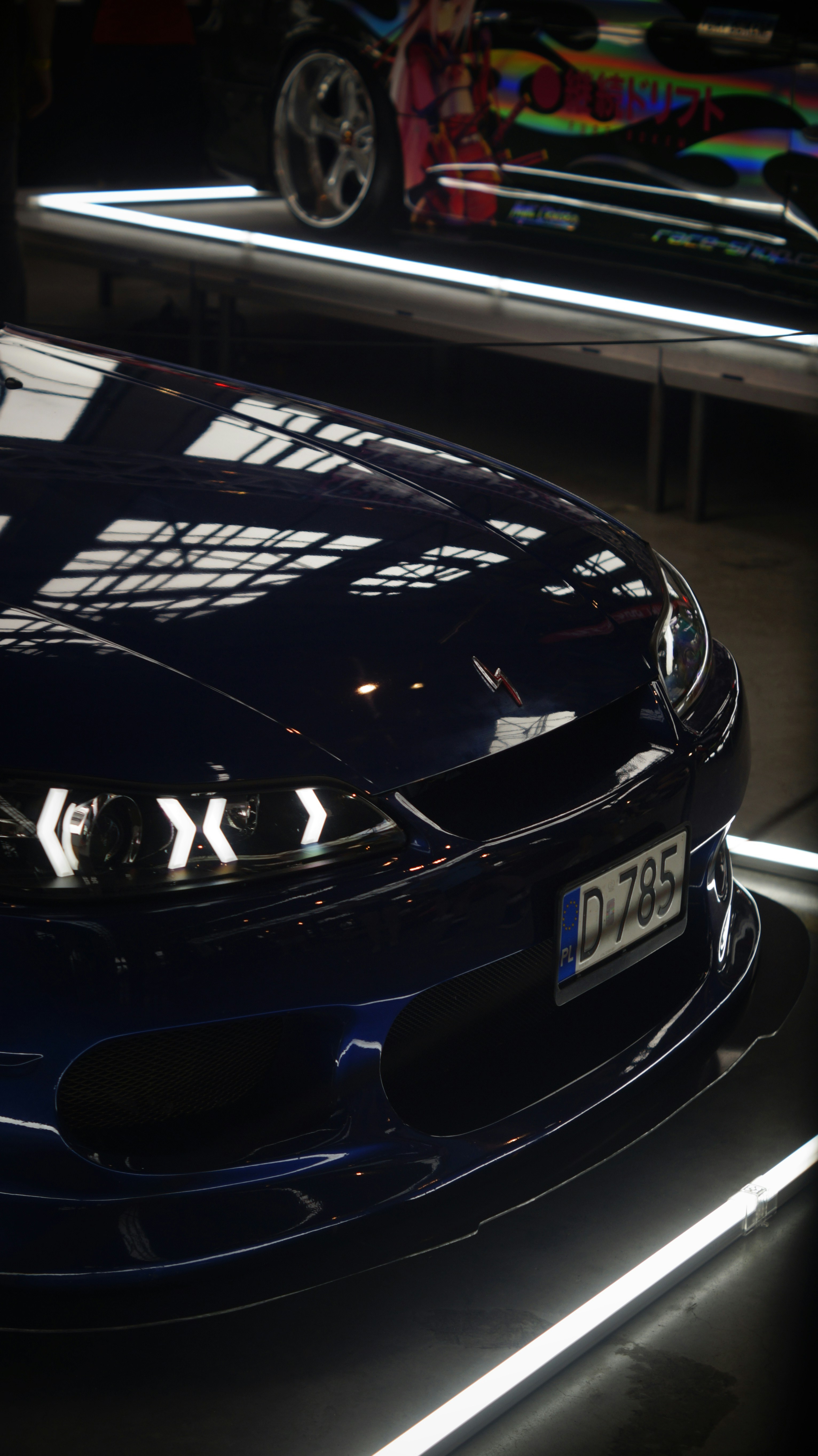 A blue sports car parked in a garage