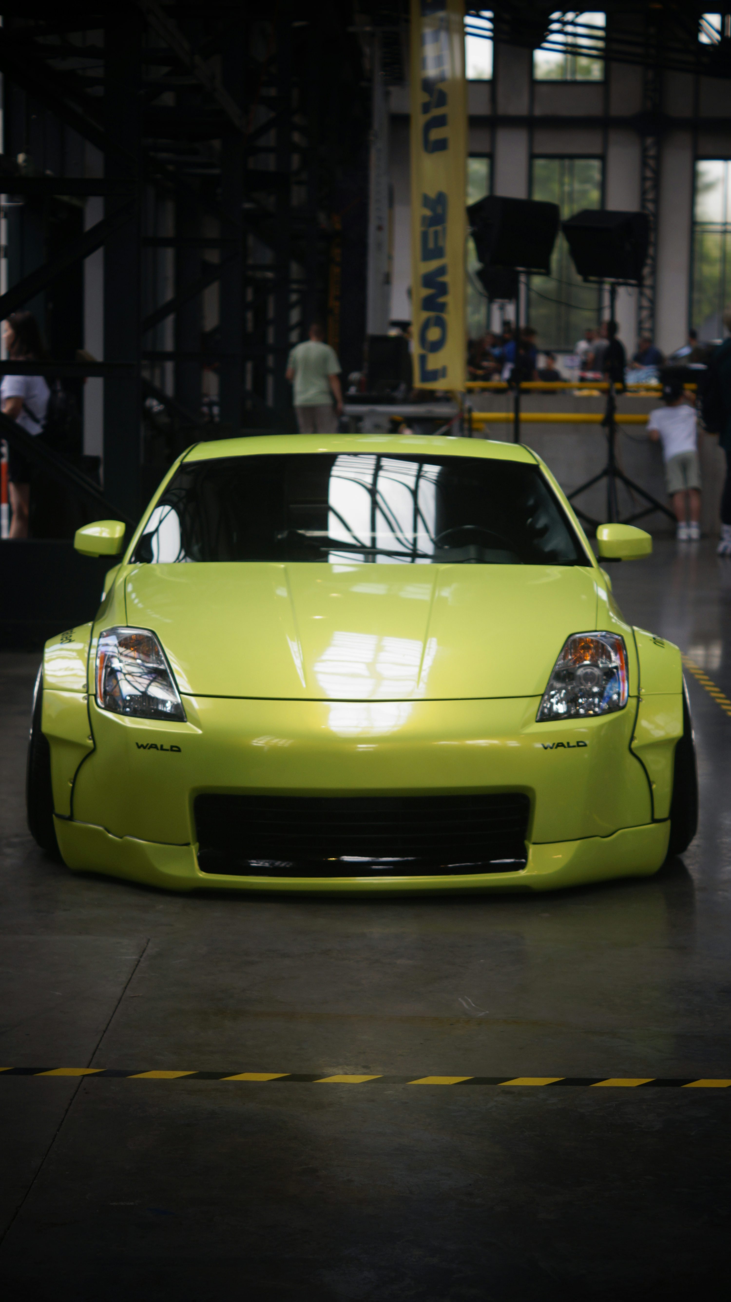 A yellow sports car parked in a garage