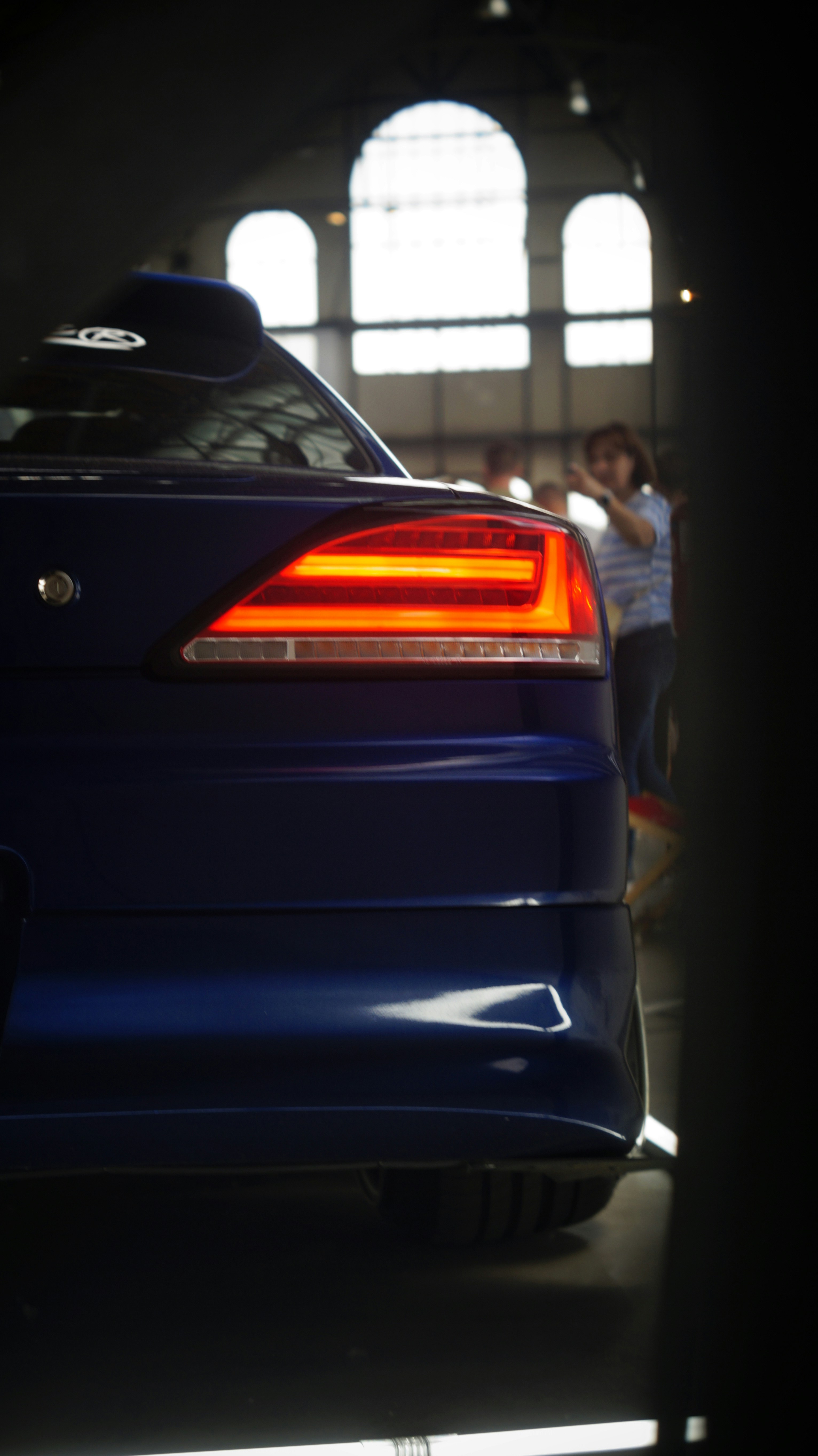 A blue sports car parked in a garage