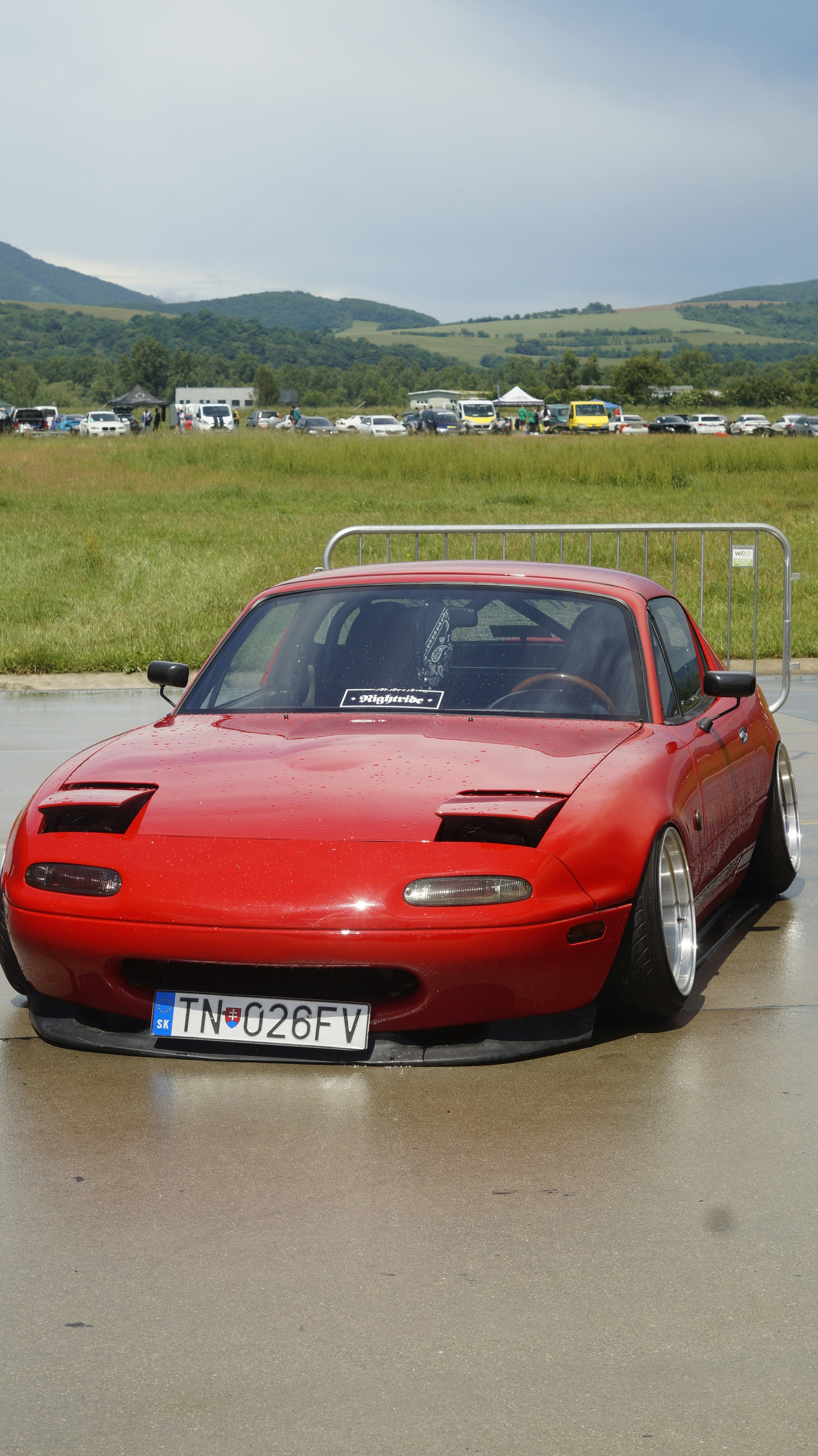 A red sports car parked in a parking lot