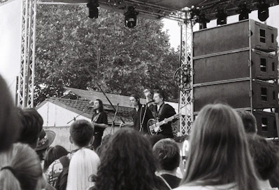 A group of people that are standing in front of a stage