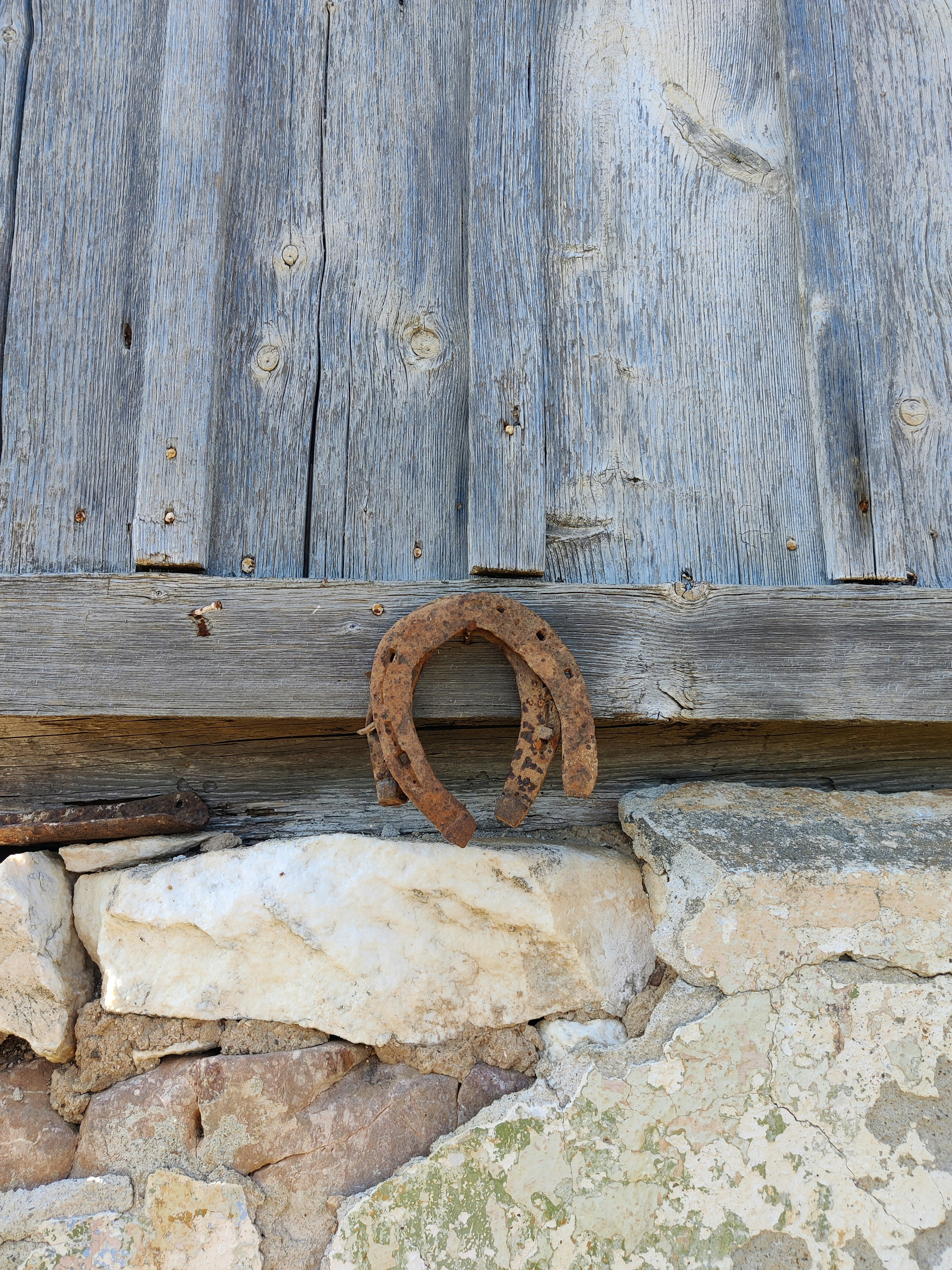 A rusted metal ring on a rock wall