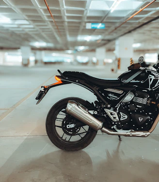 A black motorcycle parked in a parking garage