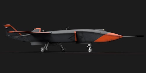 An orange and black airplane on a black background