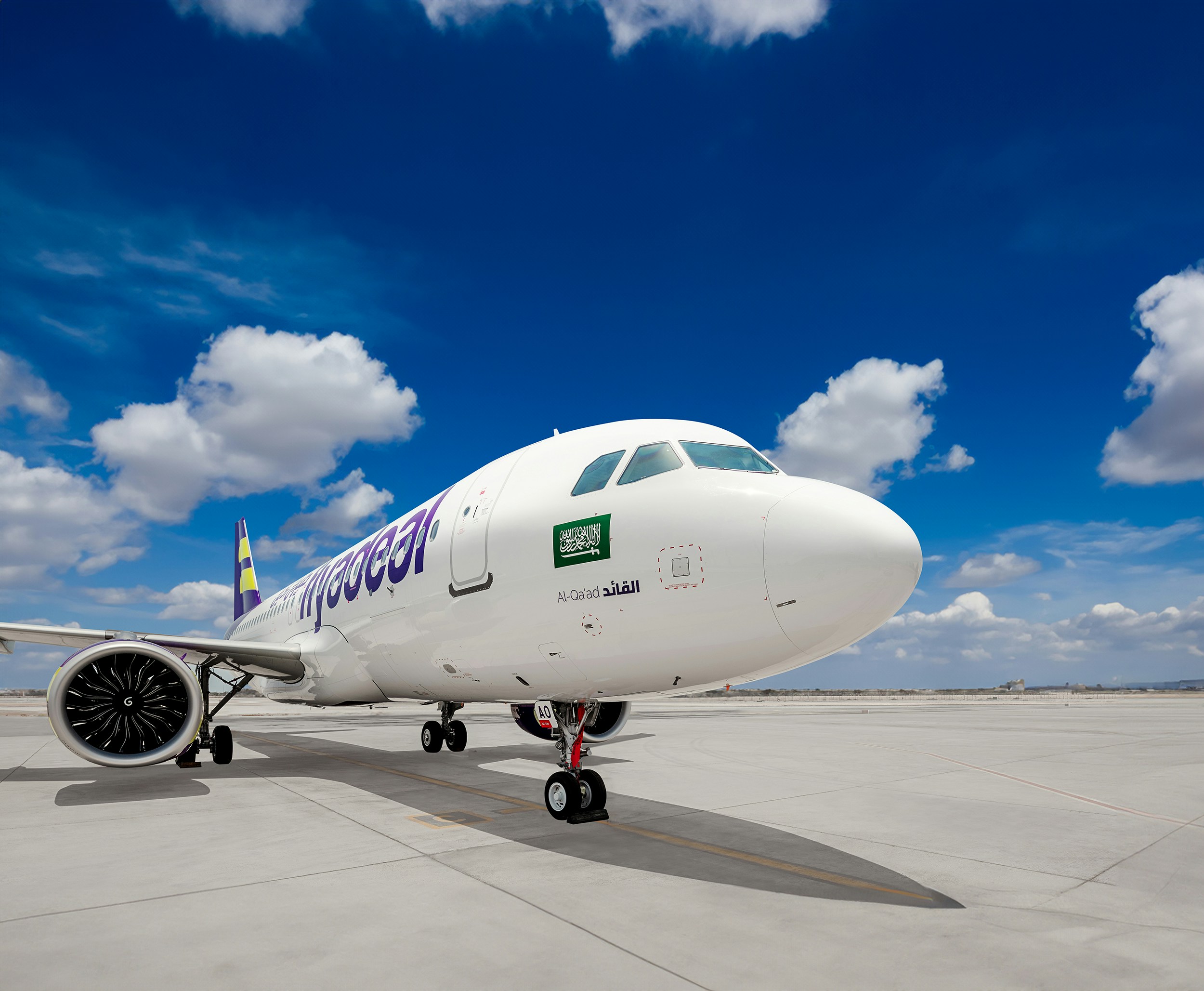 A large jetliner sitting on top of an airport tarmac, Al-Qa