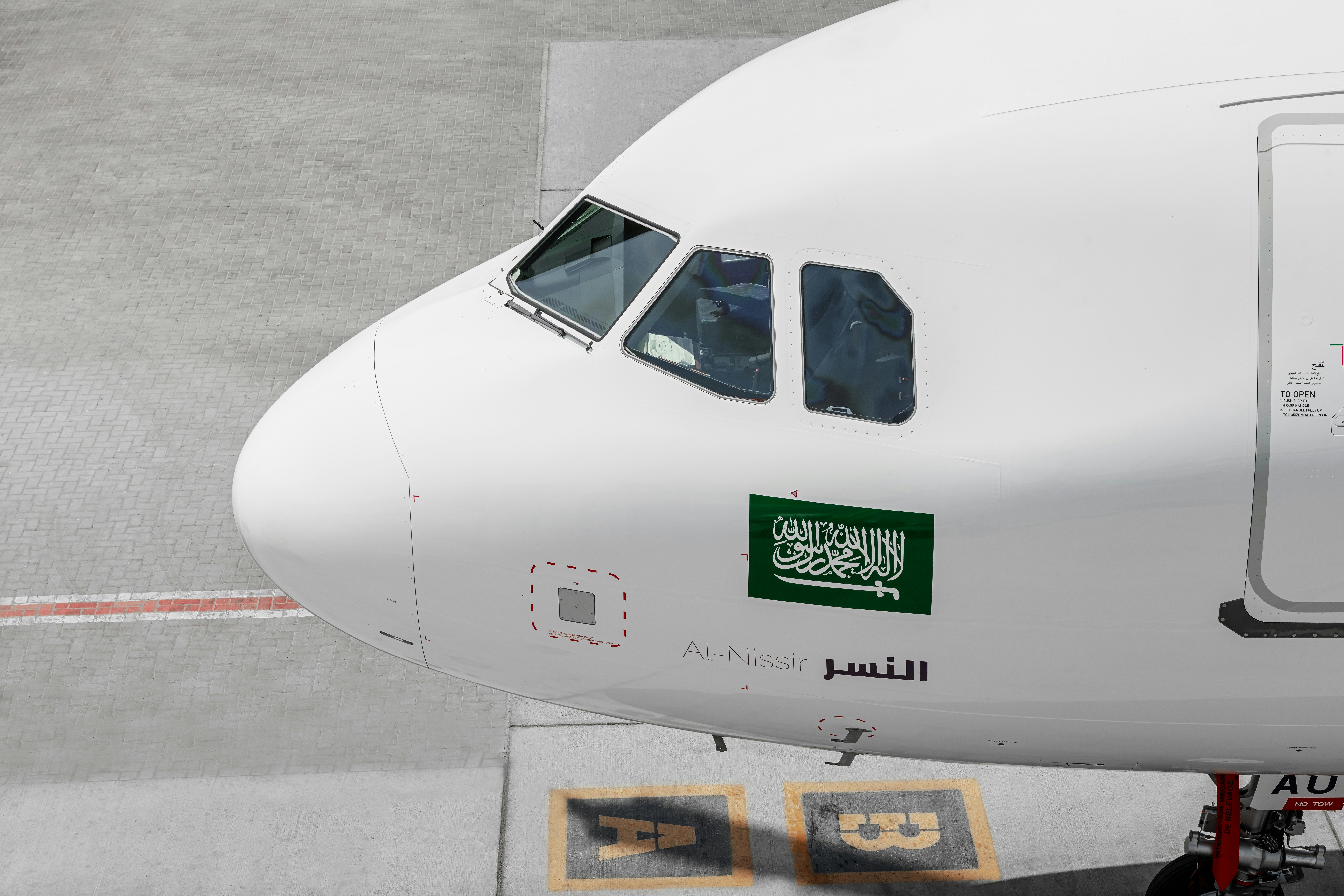 A large jetliner sitting on top of an airport tarmac, 