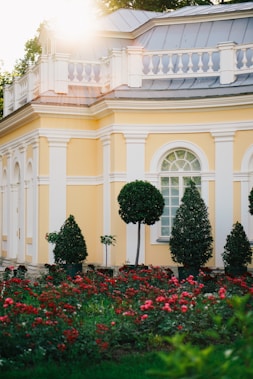 A building with a lot of flowers in front of it