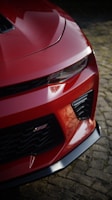 A close up of the front of a red sports car