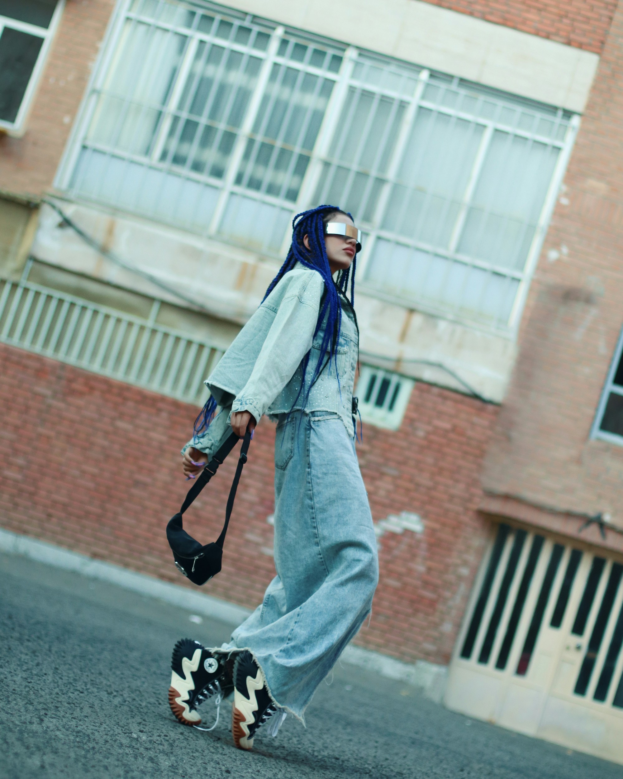 A person walking down a street with a skateboard
