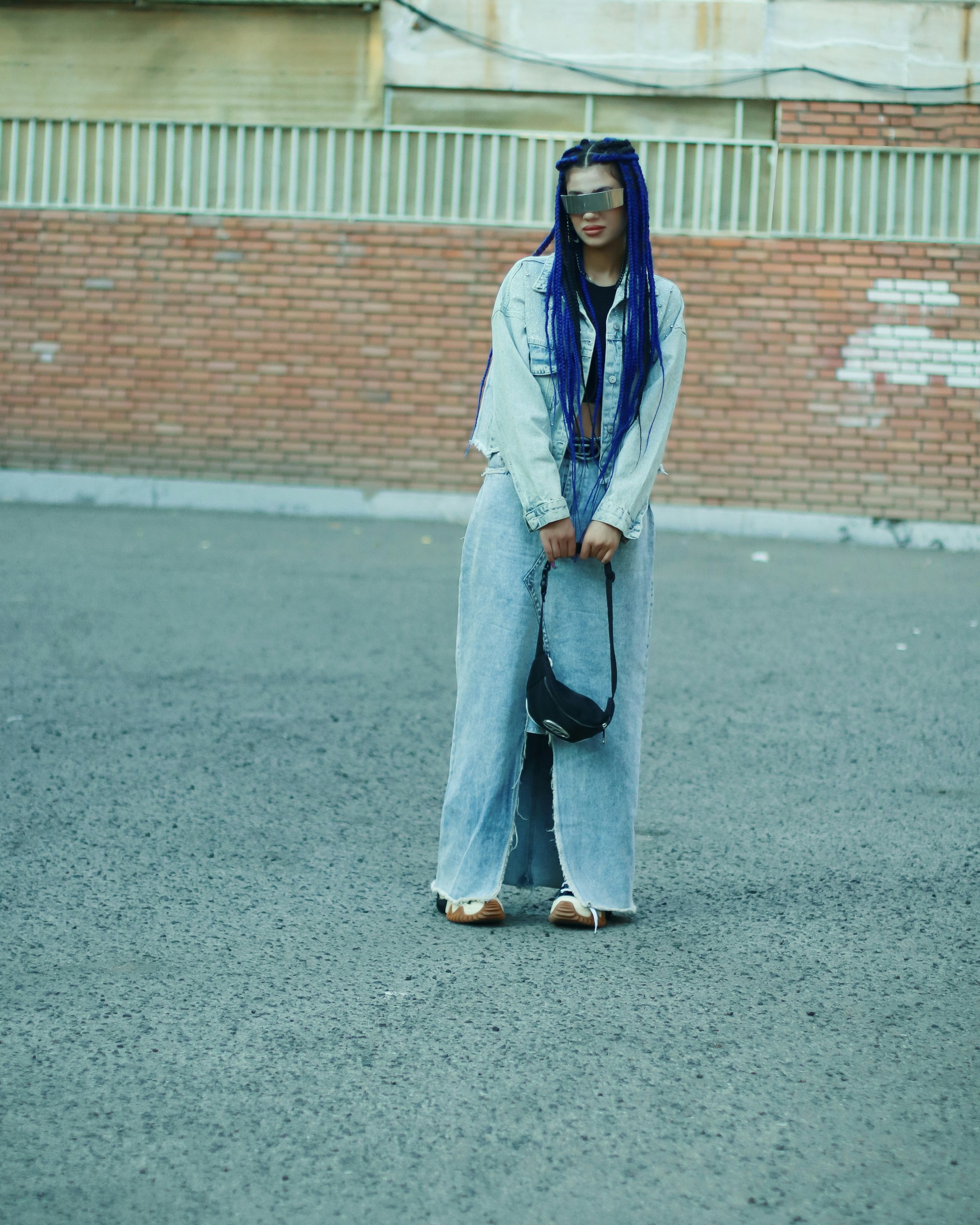 A woman standing in the middle of a street
