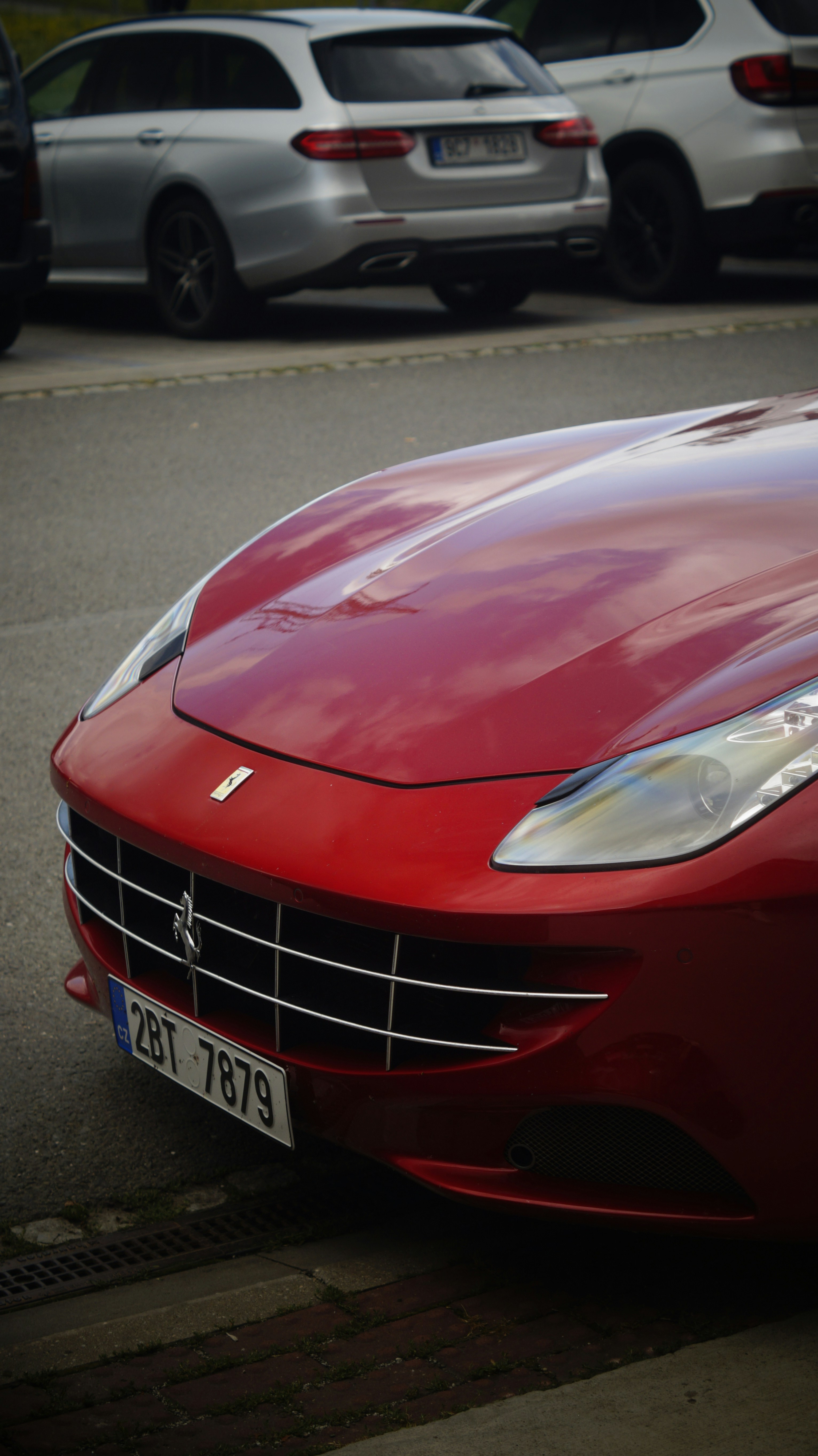 A red sports car parked on the side of the road