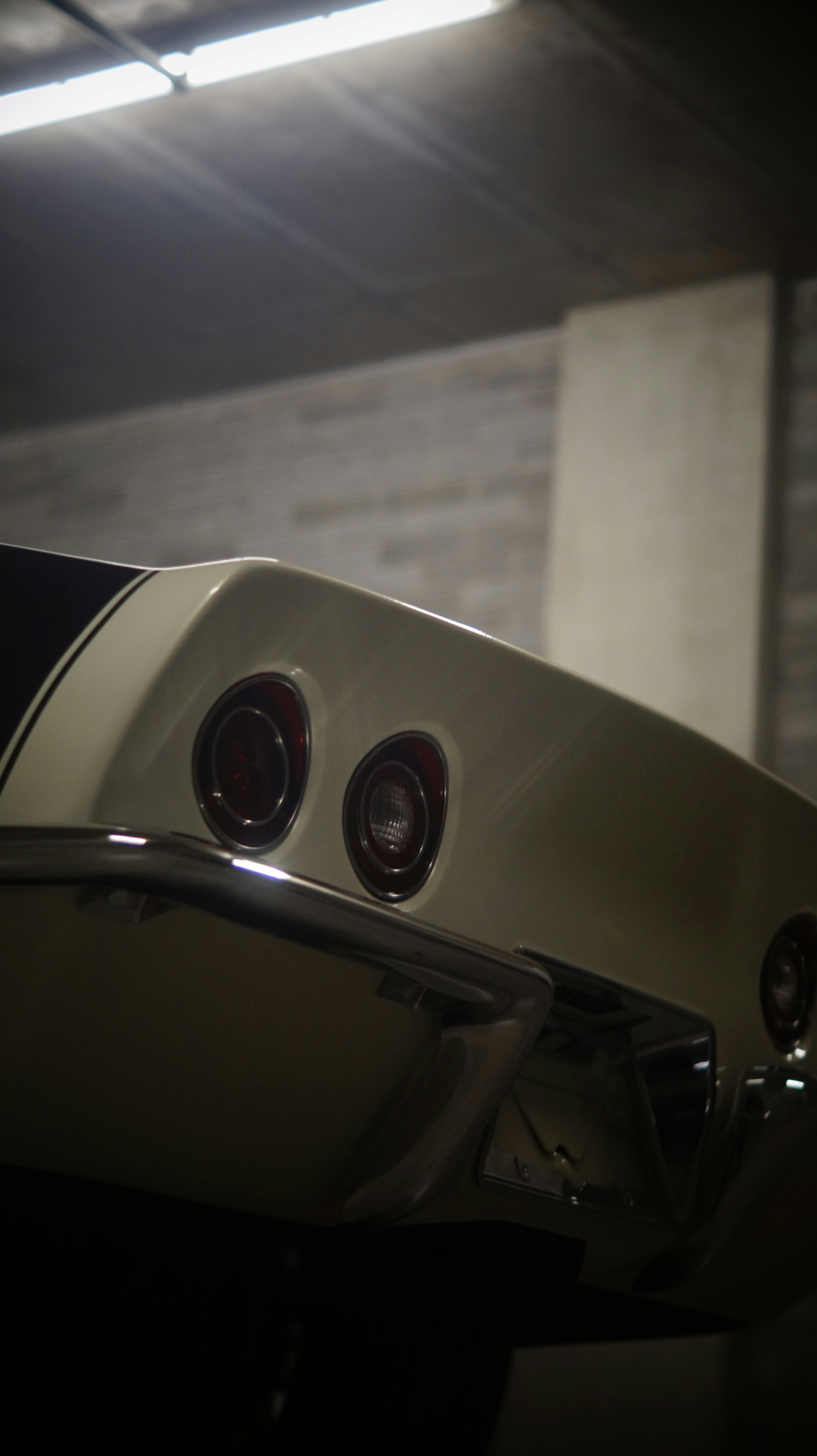 A white and black car parked in a garage