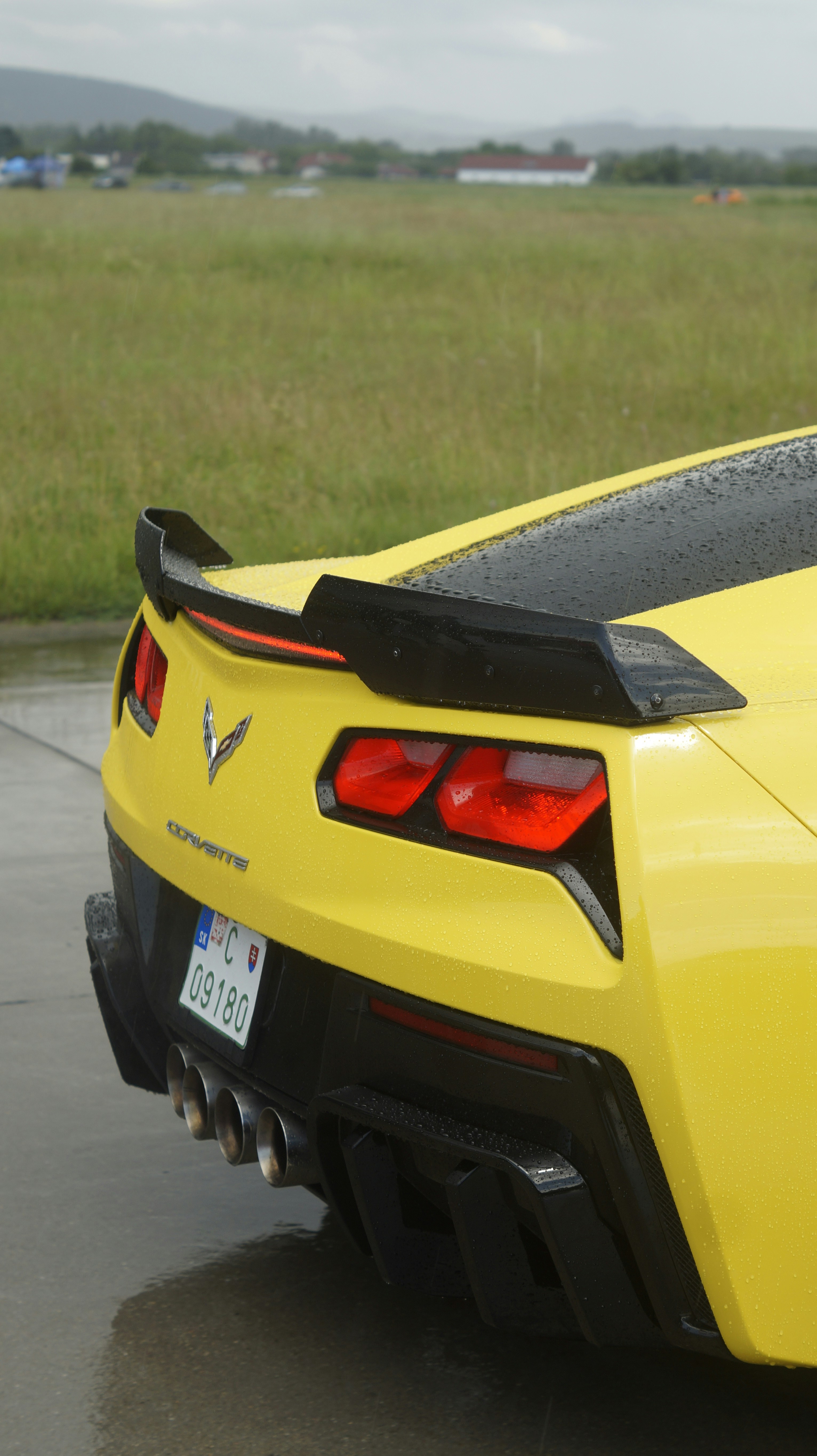 A yellow sports car parked in a parking lot