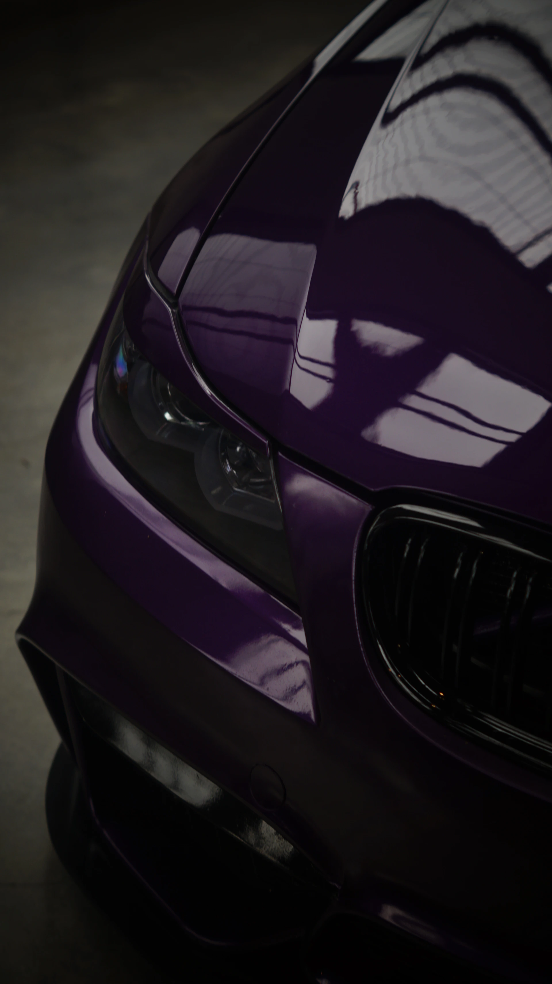 A close up of the front of a purple car