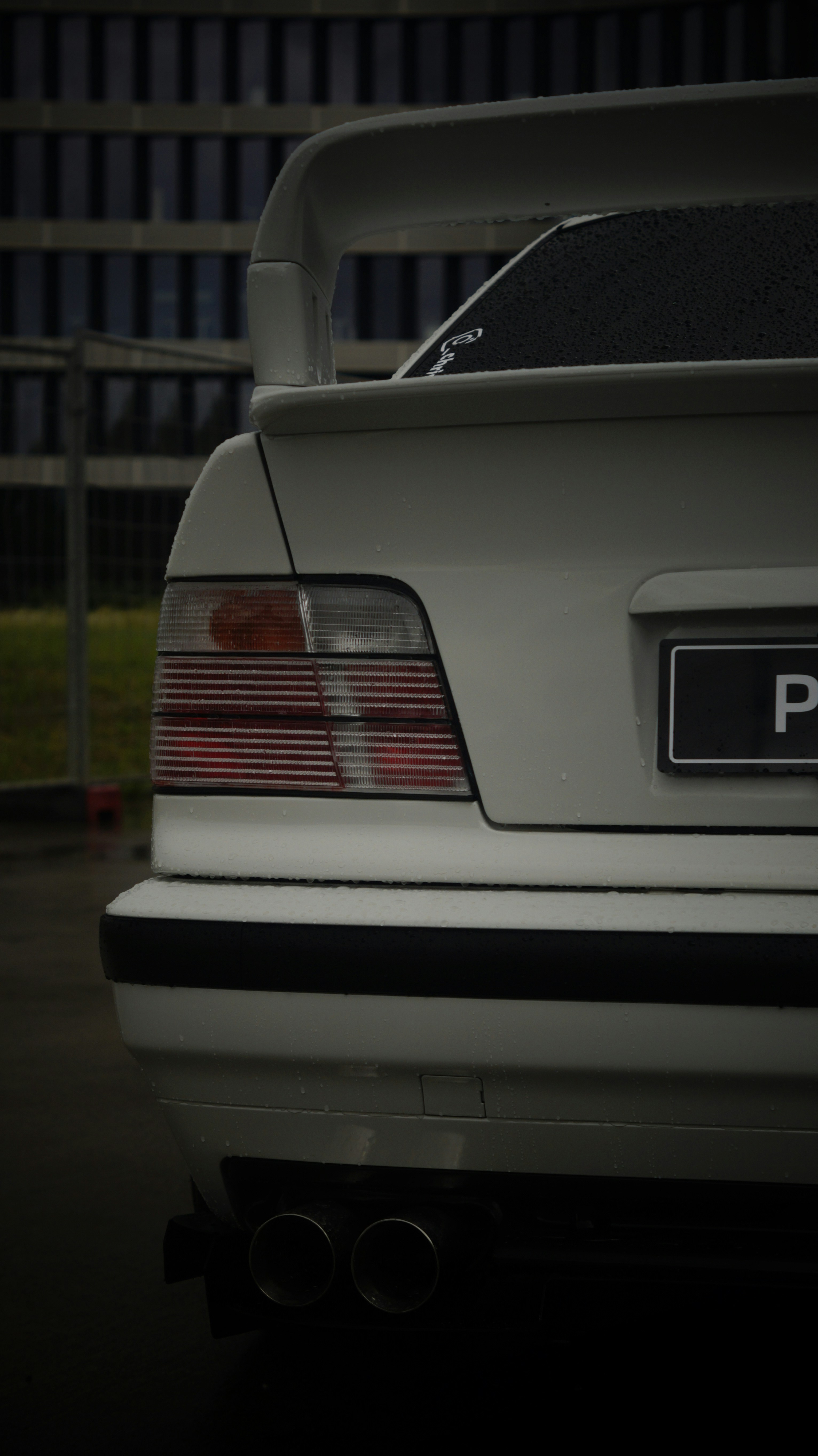 A white car parked in a parking lot at night
