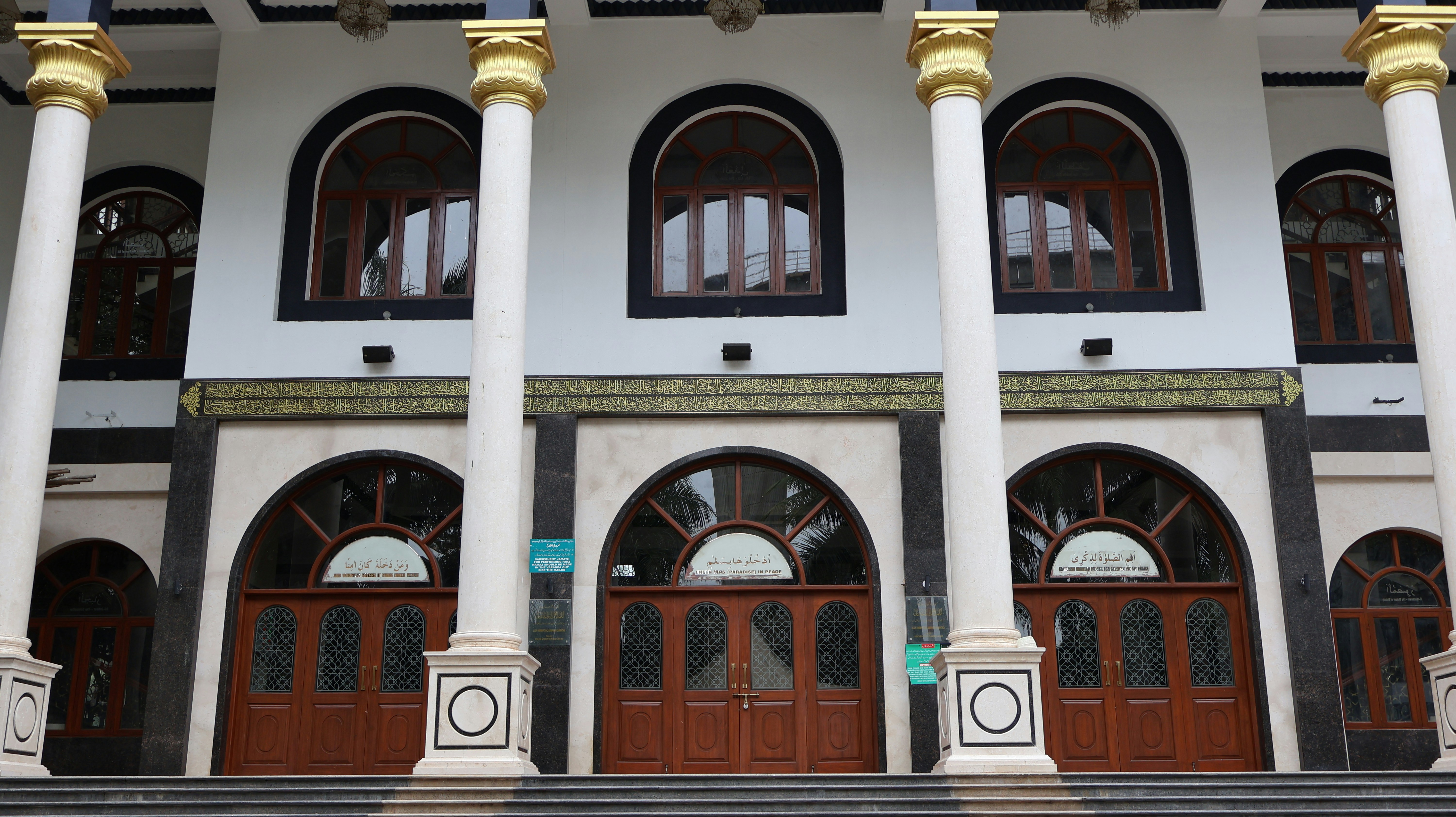 The front of a large white building with columns