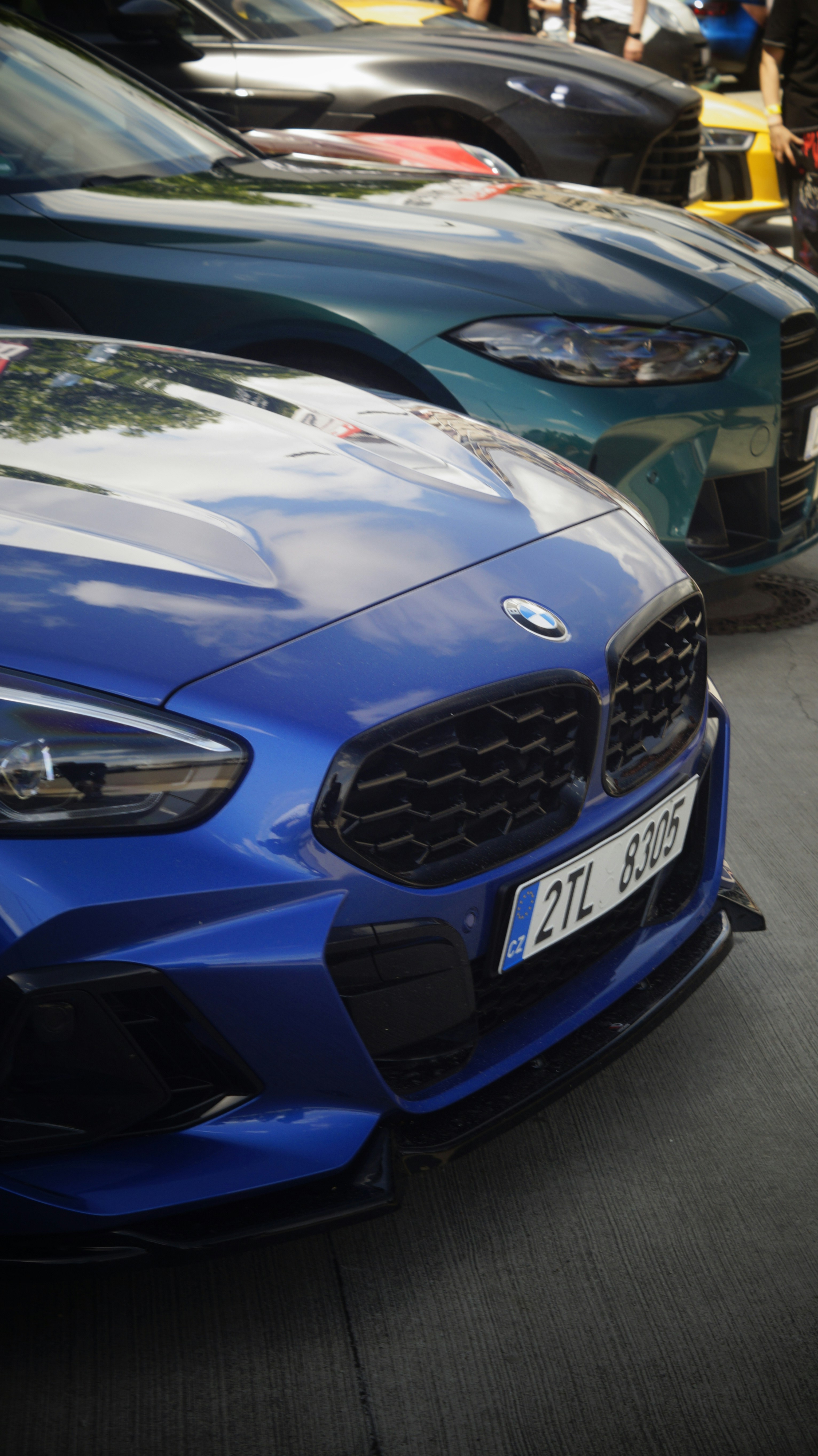 A blue car parked in front of other cars